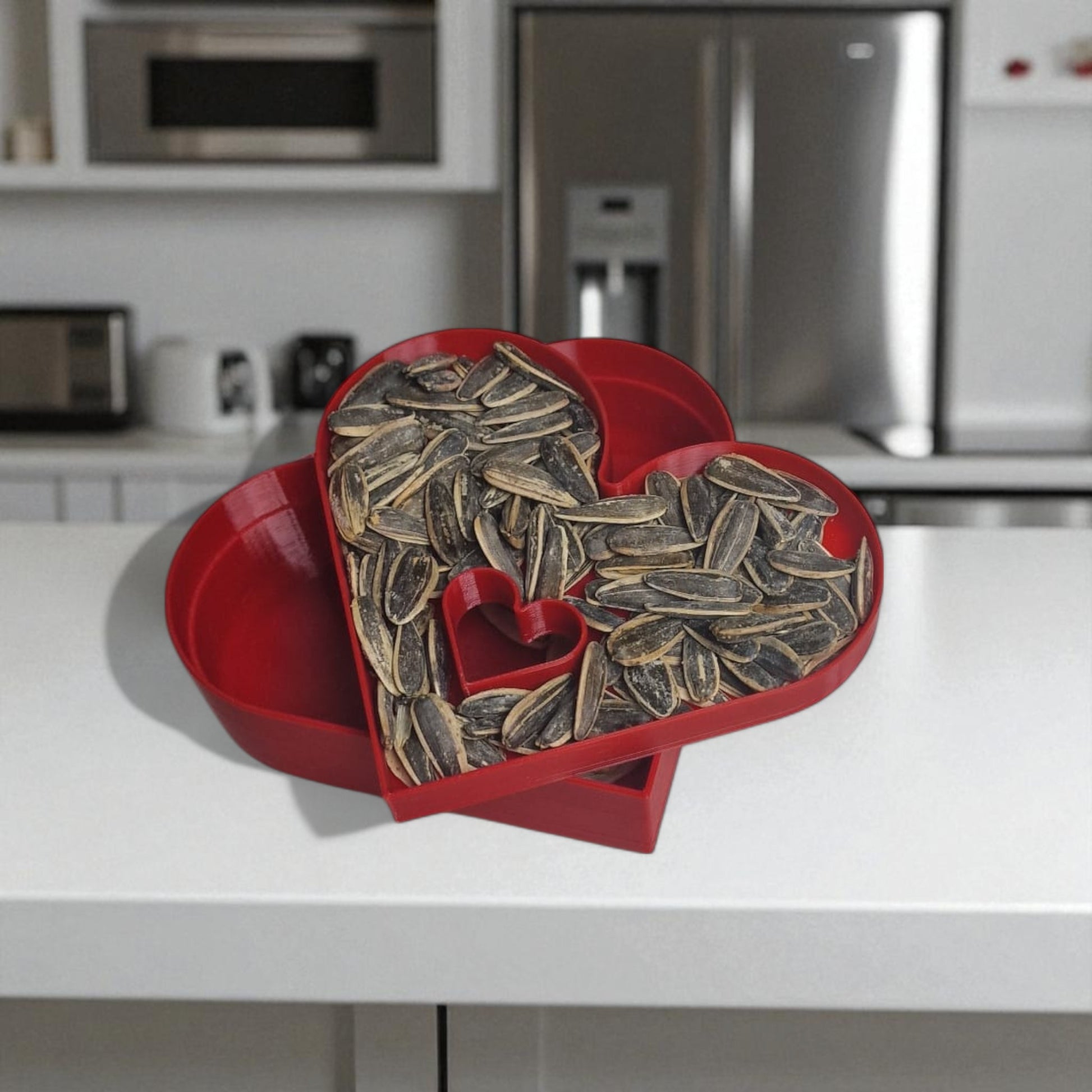 Heart-shaped container filled with sunflower seeds on a kitchen counter