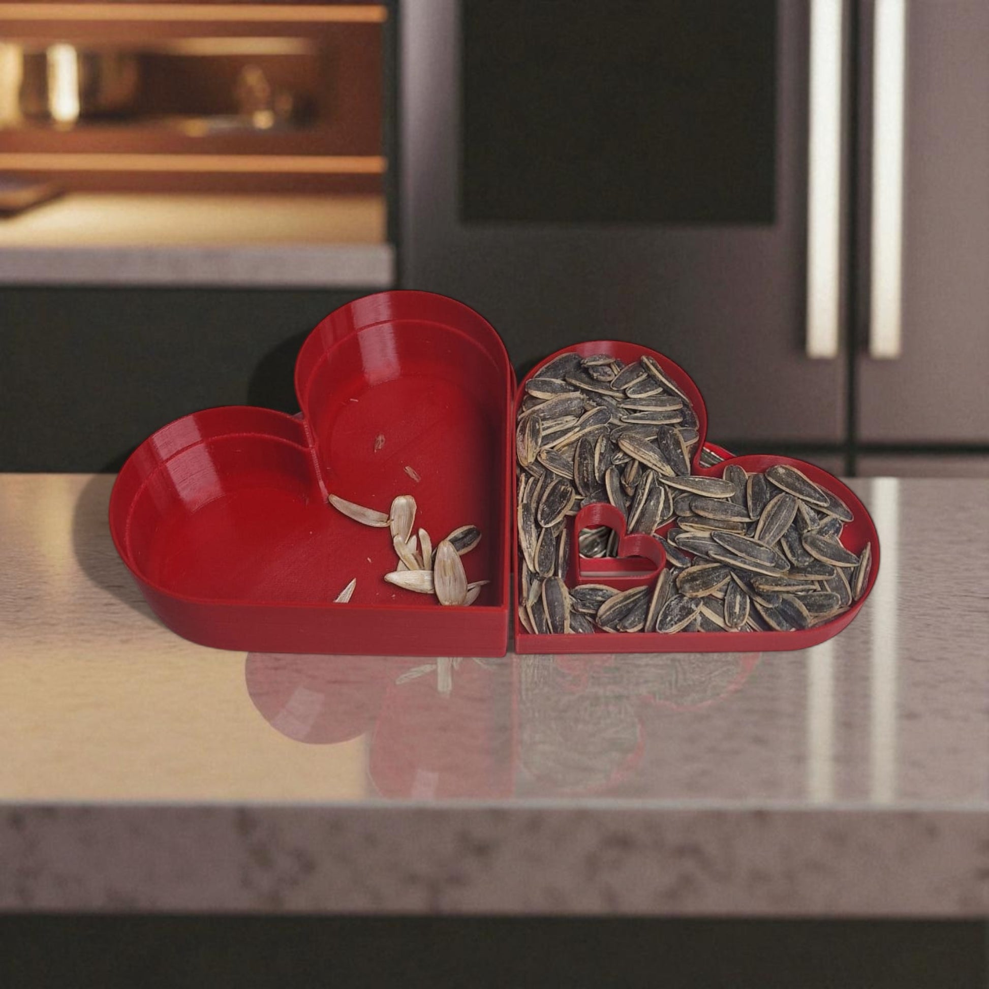 Red heart-shaped container with sunflower seeds on a kitchen counter