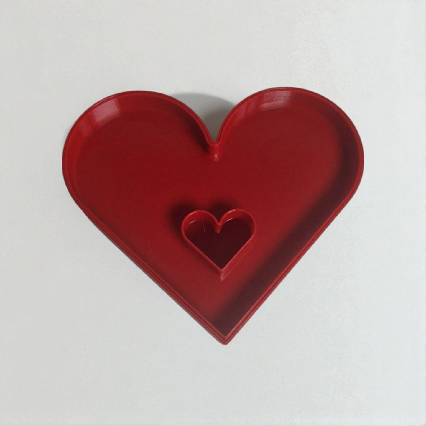 red heart-shaped object on a white background