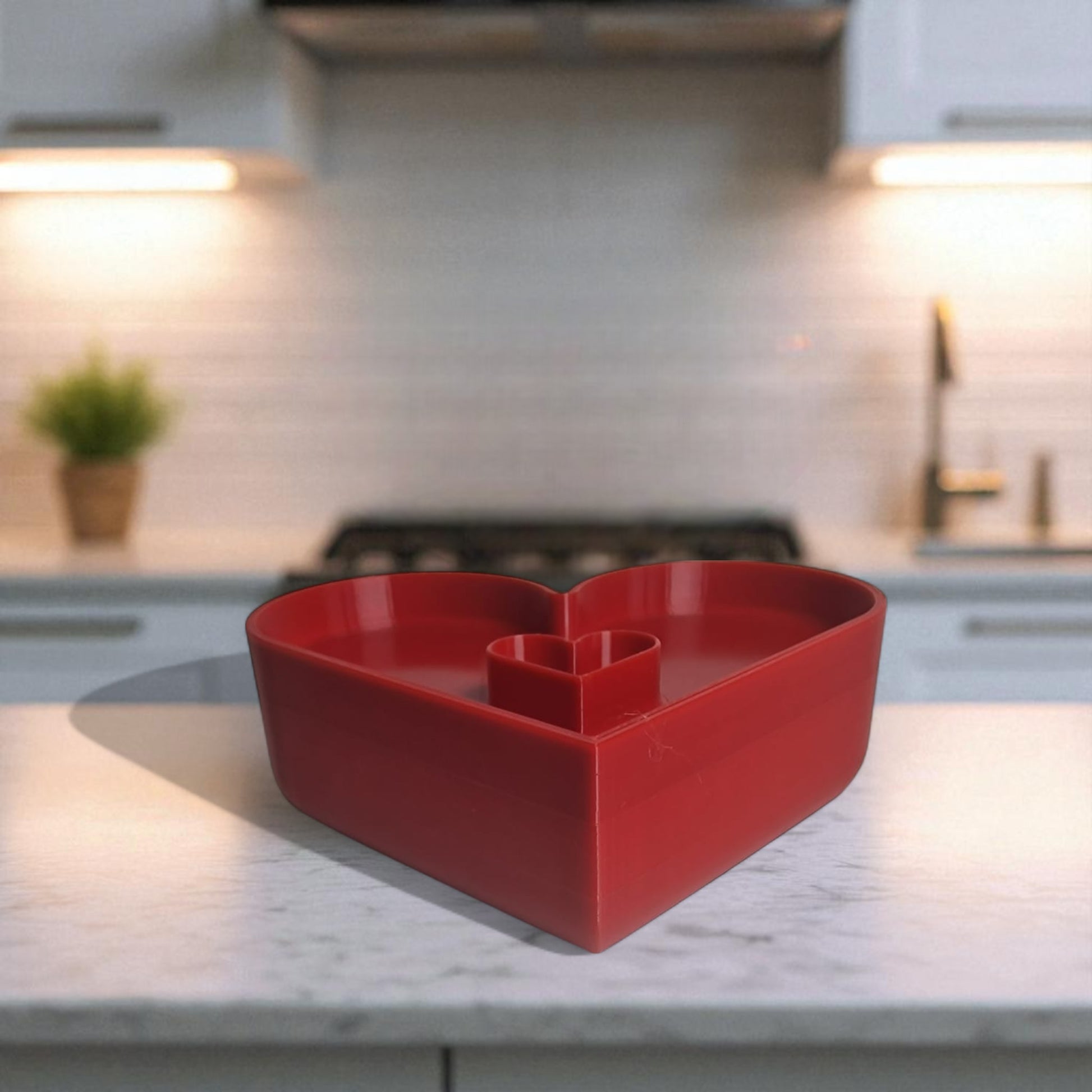 Red heart-shaped bowl on a kitchen counter
