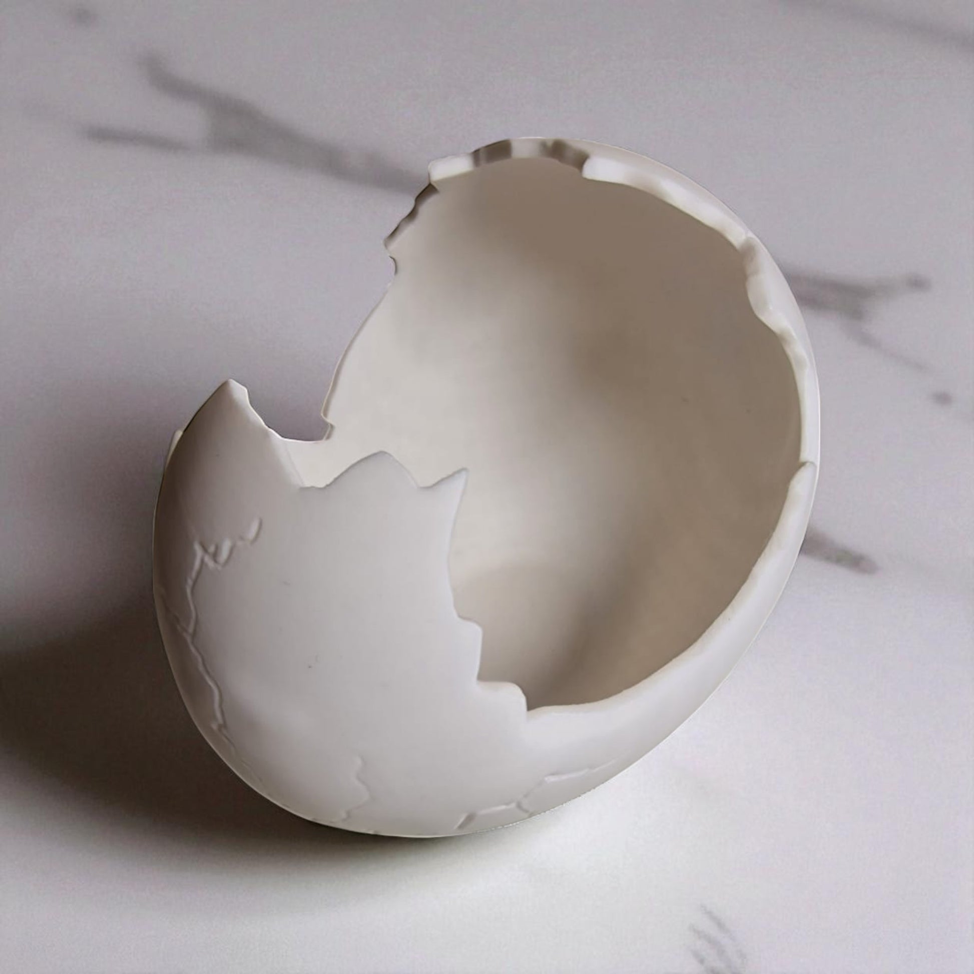 Broken eggshell on a marble surface