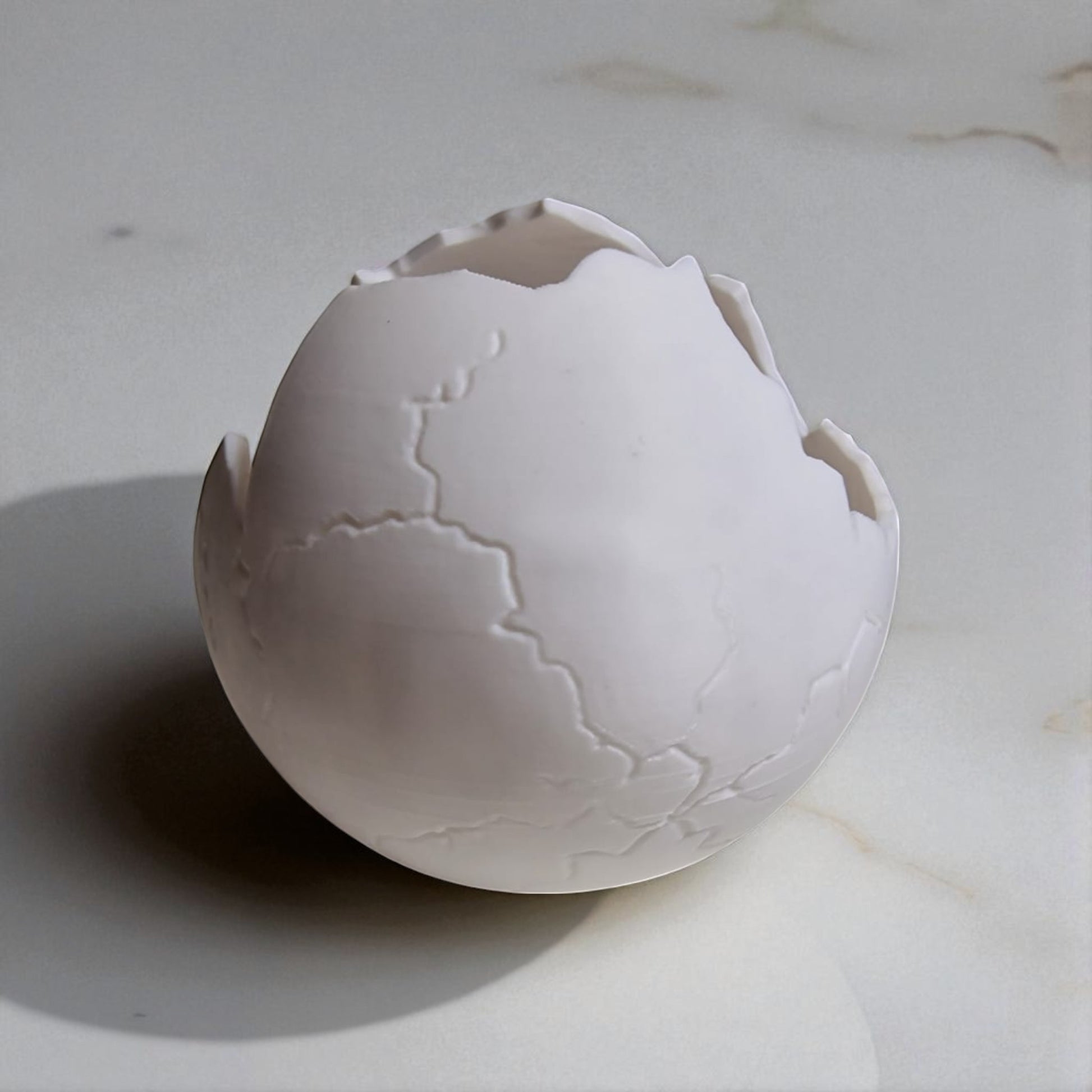 Cracked eggshell on a marble surface