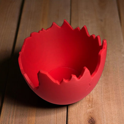 A modern cracked egg-shaped planter holding a small succulent, perfect for Easter decor and spring home styling. This unique plant pot is ideal for small to medium plants, adding a fresh and charming touch to any windowsill, desk, or shelf.