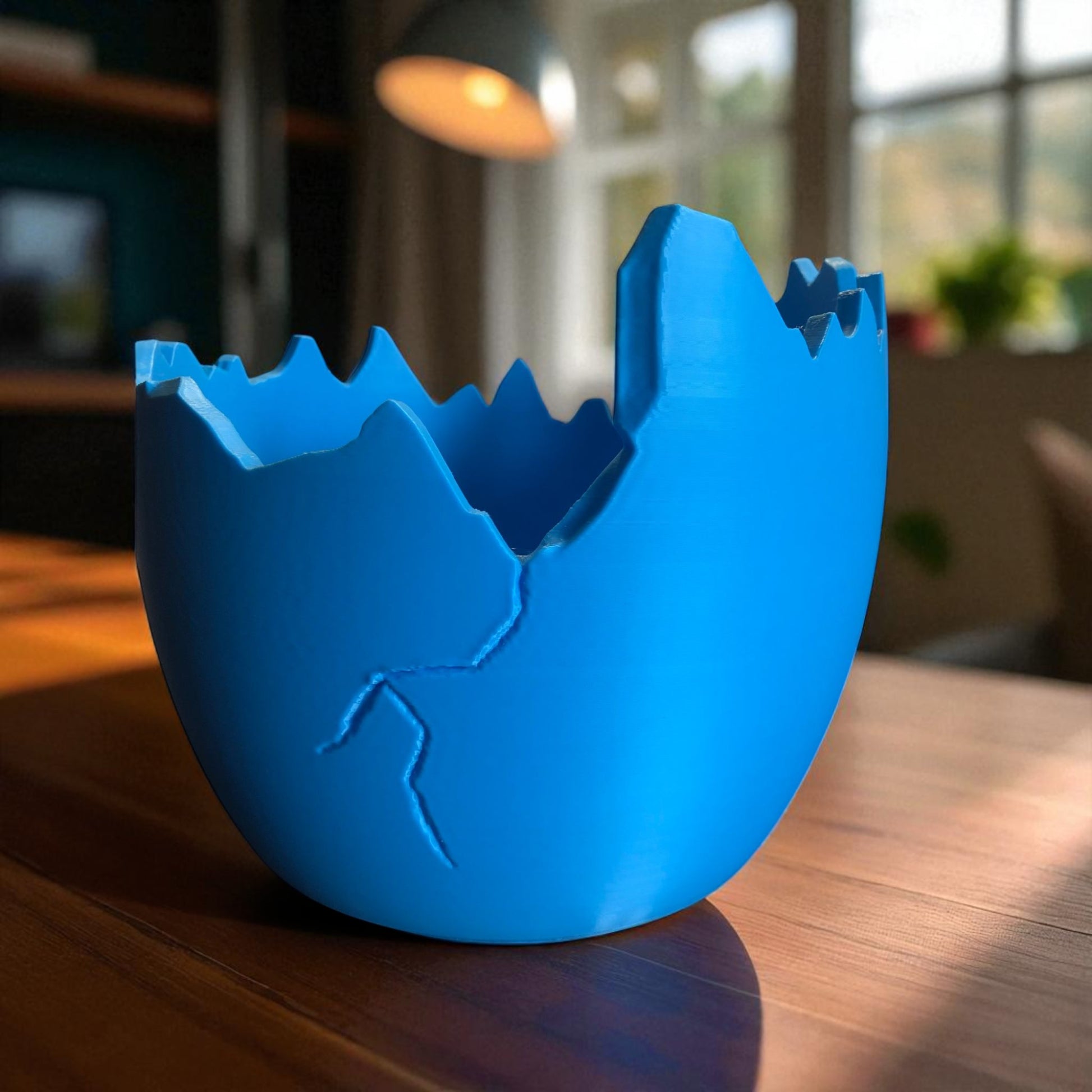 A modern cracked egg-shaped planter holding a small succulent, perfect for Easter decor and spring home styling. This unique plant pot is ideal for small to medium plants, adding a fresh and charming touch to any windowsill, desk, or shelf.