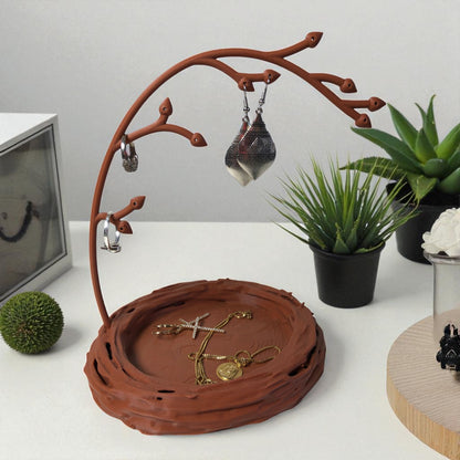 A uniquely designed bird nest jewelry tray with a branch, perfect for organizing rings, earrings, necklaces, and bracelets. The nest-shaped base includes small holes for earring storage, while the branch provides an elegant spot for hanging jewelry. Made from durable, eco-friendly 3D-printed material, this nature-inspired jewelry organizer adds a stylish and functional touch to any vanity or dresser.