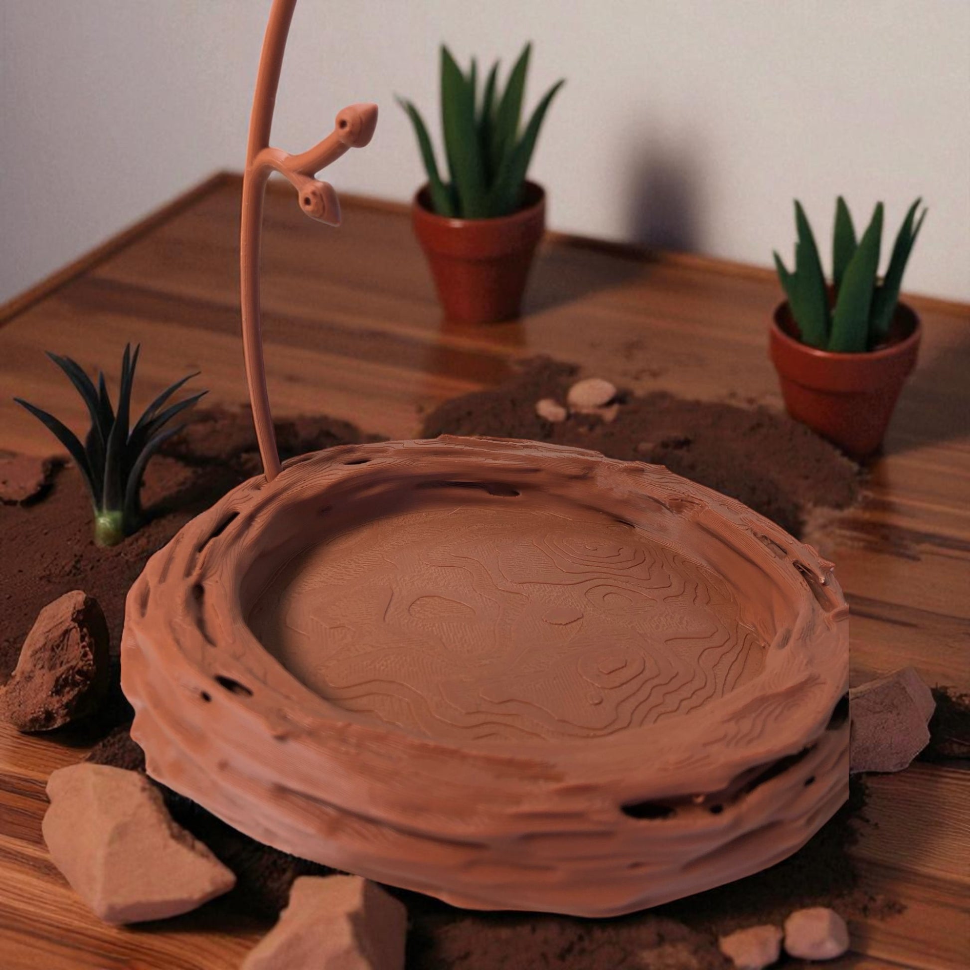 A uniquely designed bird nest jewelry tray with a branch, perfect for organizing rings, earrings, necklaces, and bracelets. The nest-shaped base includes small holes for earring storage, while the branch provides an elegant spot for hanging jewelry. Made from durable, eco-friendly 3D-printed material, this nature-inspired jewelry organizer adds a stylish and functional touch to any vanity or dresser.