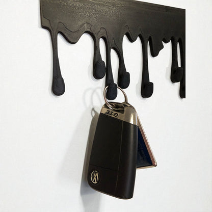 Modern Dripping Key Hanger with a unique dripping paint design, available in small (180mm x 90mm) and large (239mm x 120mm) sizes. Holds up to 9 key sets and can be mounted with adhesive strips for a rent-friendly option or secured with screws for a permanent installation. A stylish and functional wall-mounted key organizer for homes, apartments, and offices.