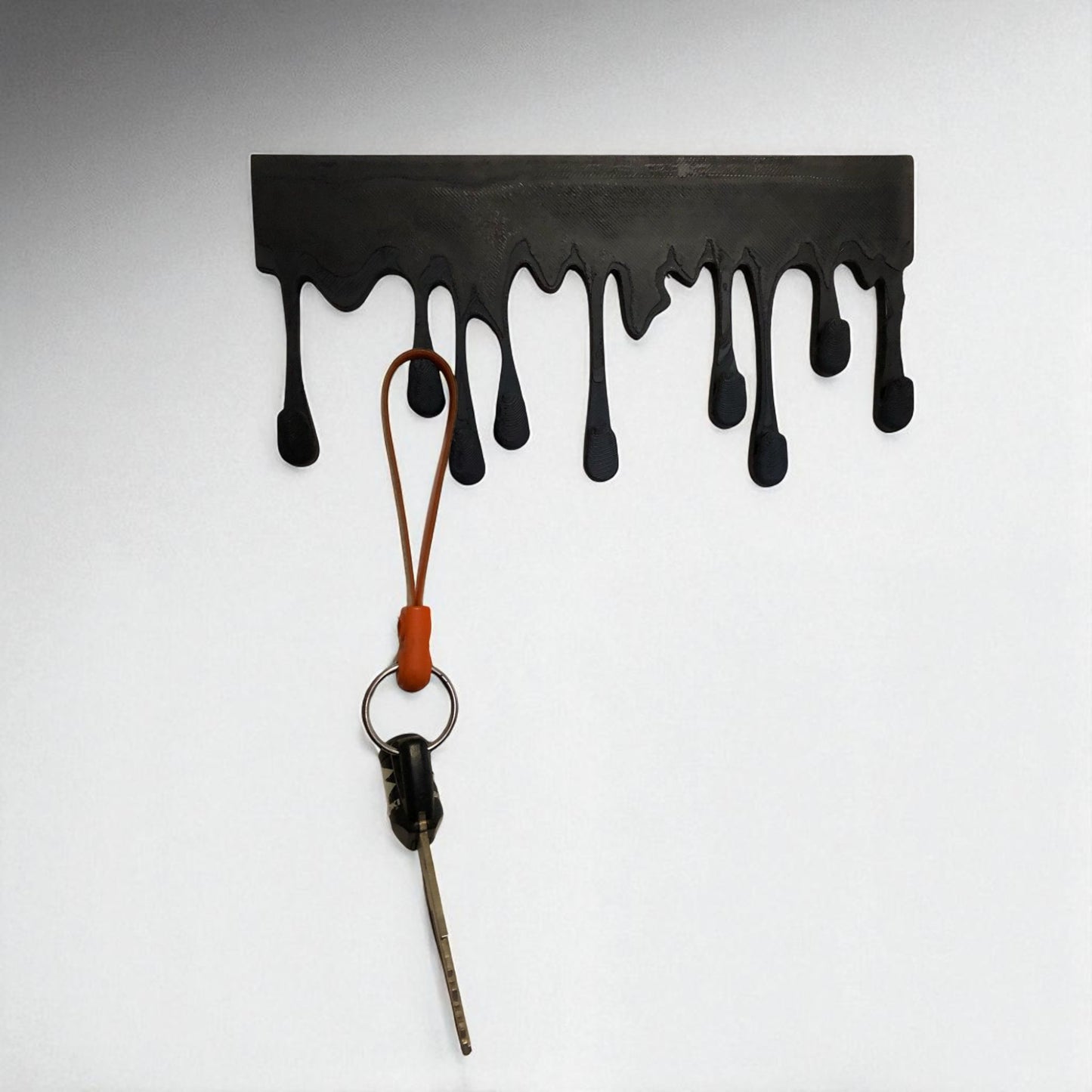 modern dripping key hanger with a unique dripping paint design, available in small (180mm x 90mm) and large (239mm x 120mm) sizes. holds up to 9 key sets and can be mounted with adhesive strips for a rent-friendly option or secured with screws for a permanent installation. a stylish and functional wall-mounted key organizer for homes, apartments, and offices.