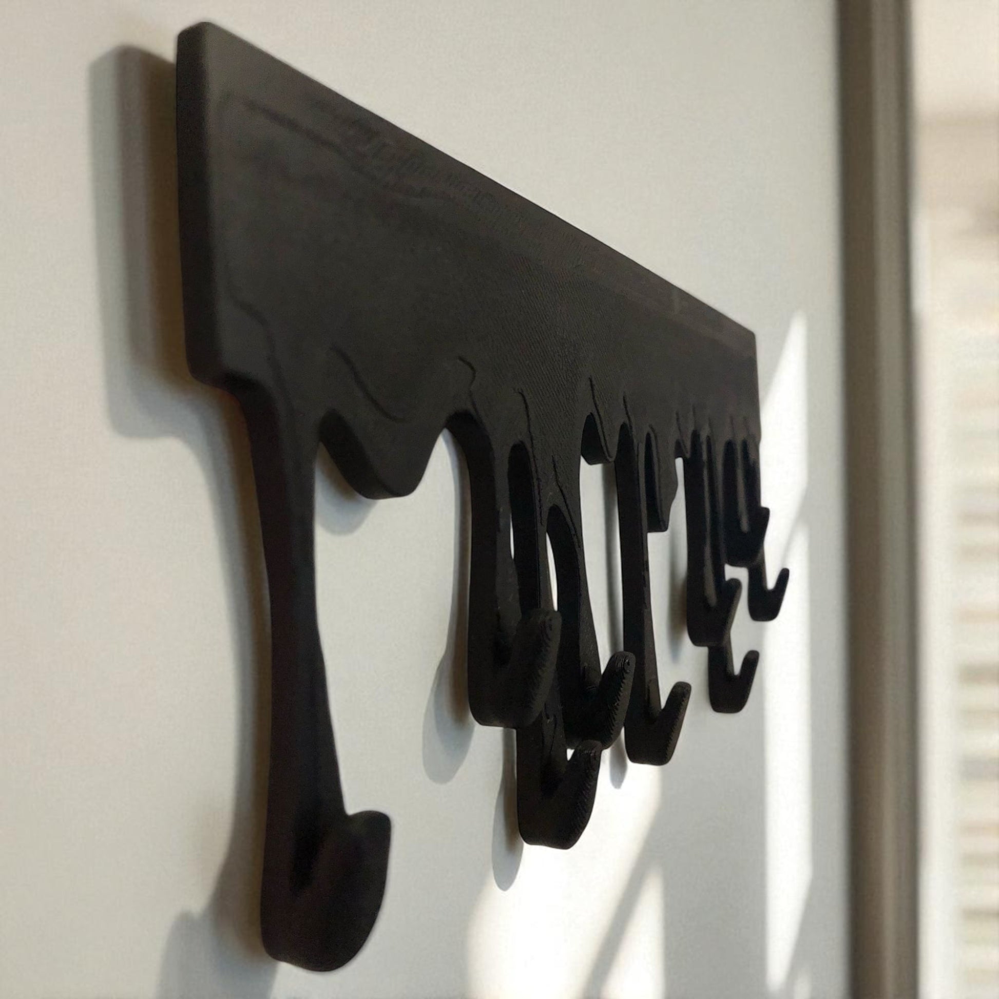 Modern Dripping Key Hanger with a unique dripping paint design, available in small (180mm x 90mm) and large (239mm x 120mm) sizes. Holds up to 9 key sets and can be mounted with adhesive strips for a rent-friendly option or secured with screws for a permanent installation. A stylish and functional wall-mounted key organizer for homes, apartments, and offices.