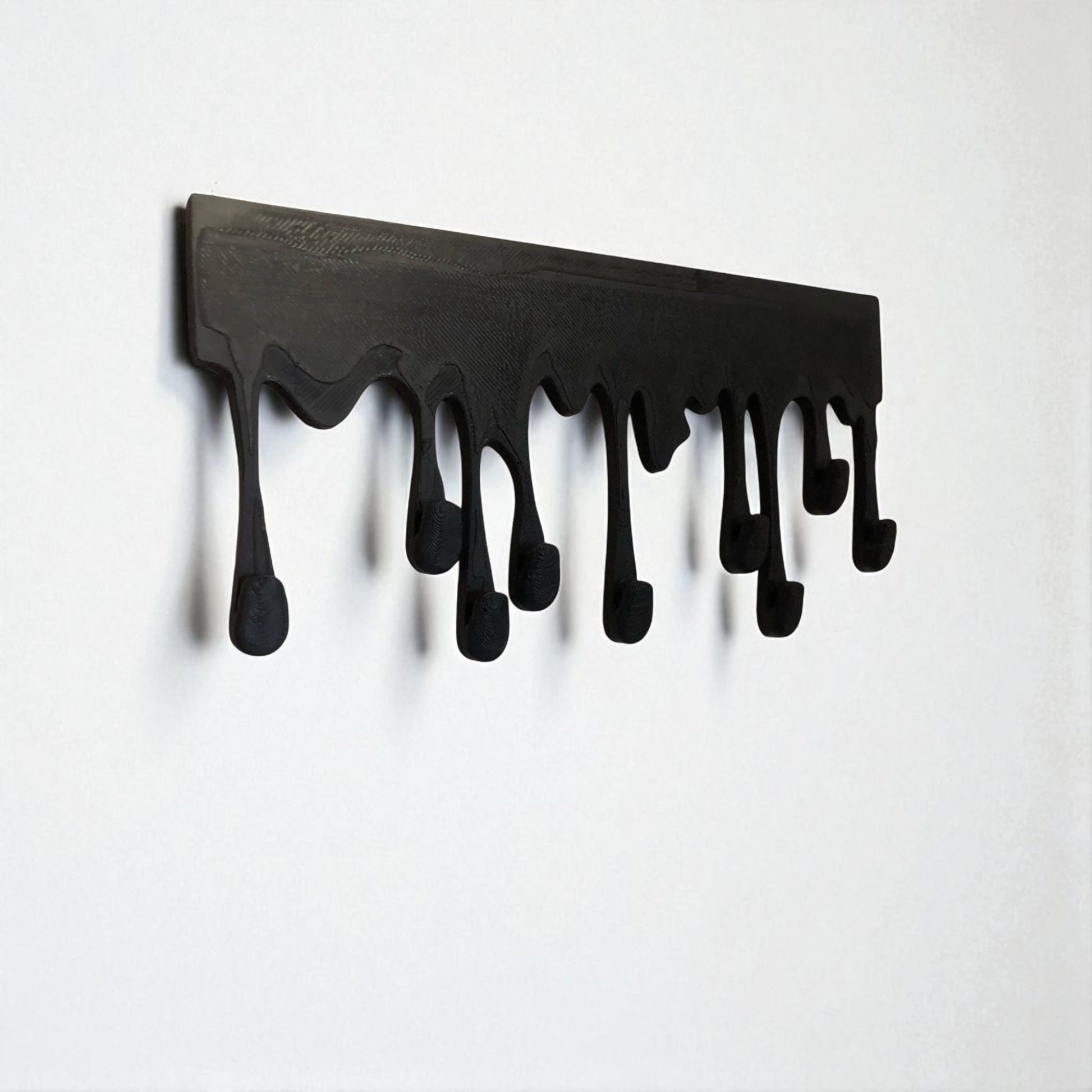 Modern Dripping Key Hanger with a unique dripping paint design, available in small (180mm x 90mm) and large (239mm x 120mm) sizes. Holds up to 9 key sets and can be mounted with adhesive strips for a rent-friendly option or secured with screws for a permanent installation. A stylish and functional wall-mounted key organizer for homes, apartments, and offices.