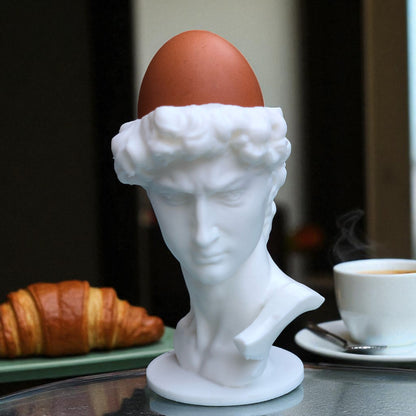 3D printed male bust egg cup in classical sculpture style, featuring a hollowed head holding a boiled egg. Unique breakfast decor piece in white PLA, perfect for Easter table settings or artistic kitchen gifts.