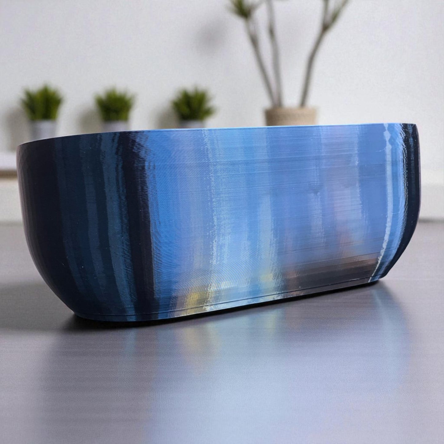 modern rectangular wall planter with rounded corners, mounted on a wall and planted with fresh herbs like parsley, coriander, and basil. the large 3d printed planter is shown in use indoors, highlighting its sleek design and easy wall-mount installation with screws or tape