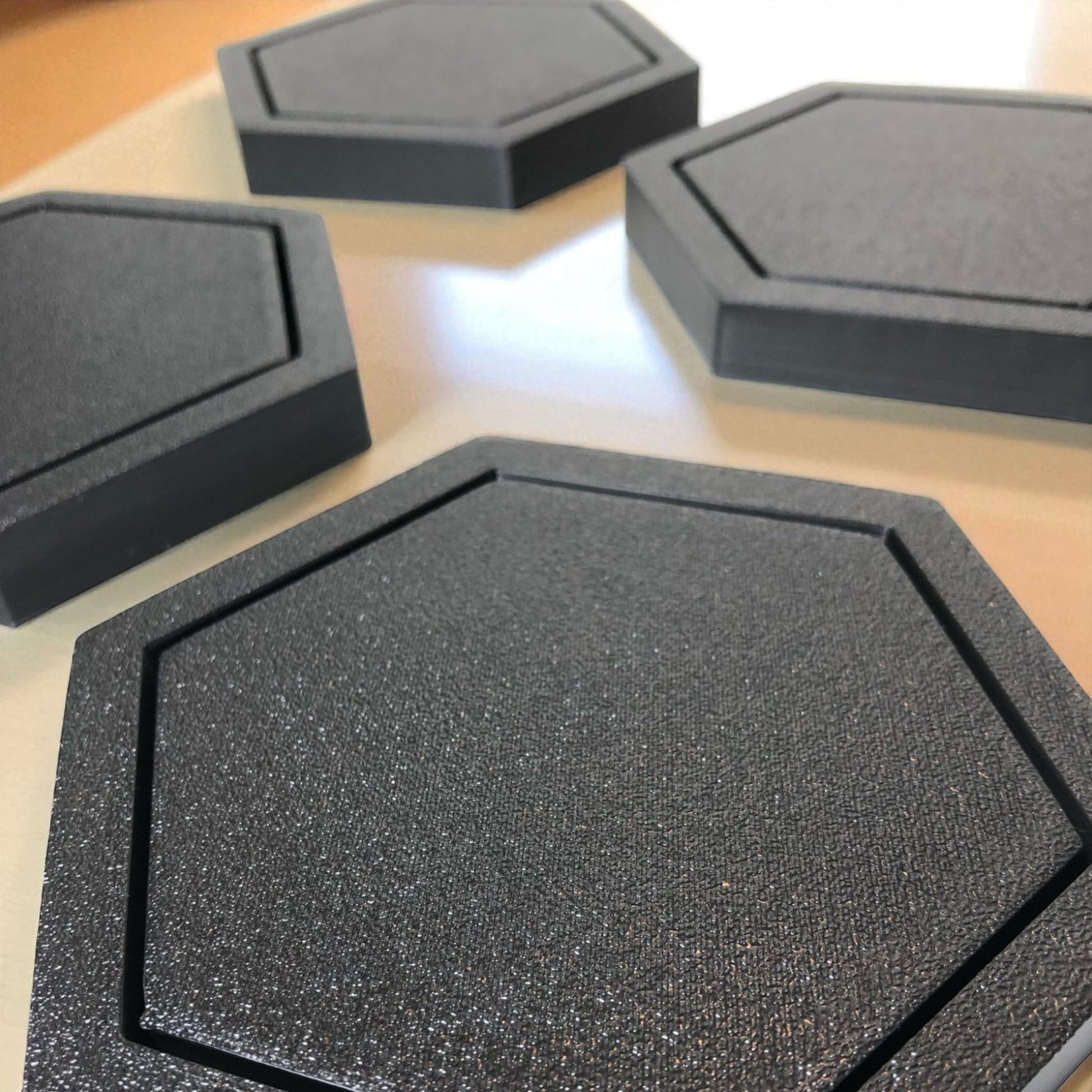 Modern hexagonal coaster in a minimalist design, measuring 115mm x 14mm, perfect for protecting surfaces from hot drinks. Available as a single piece, set of 4, or set of 6. Durable and stylish home decor accessory