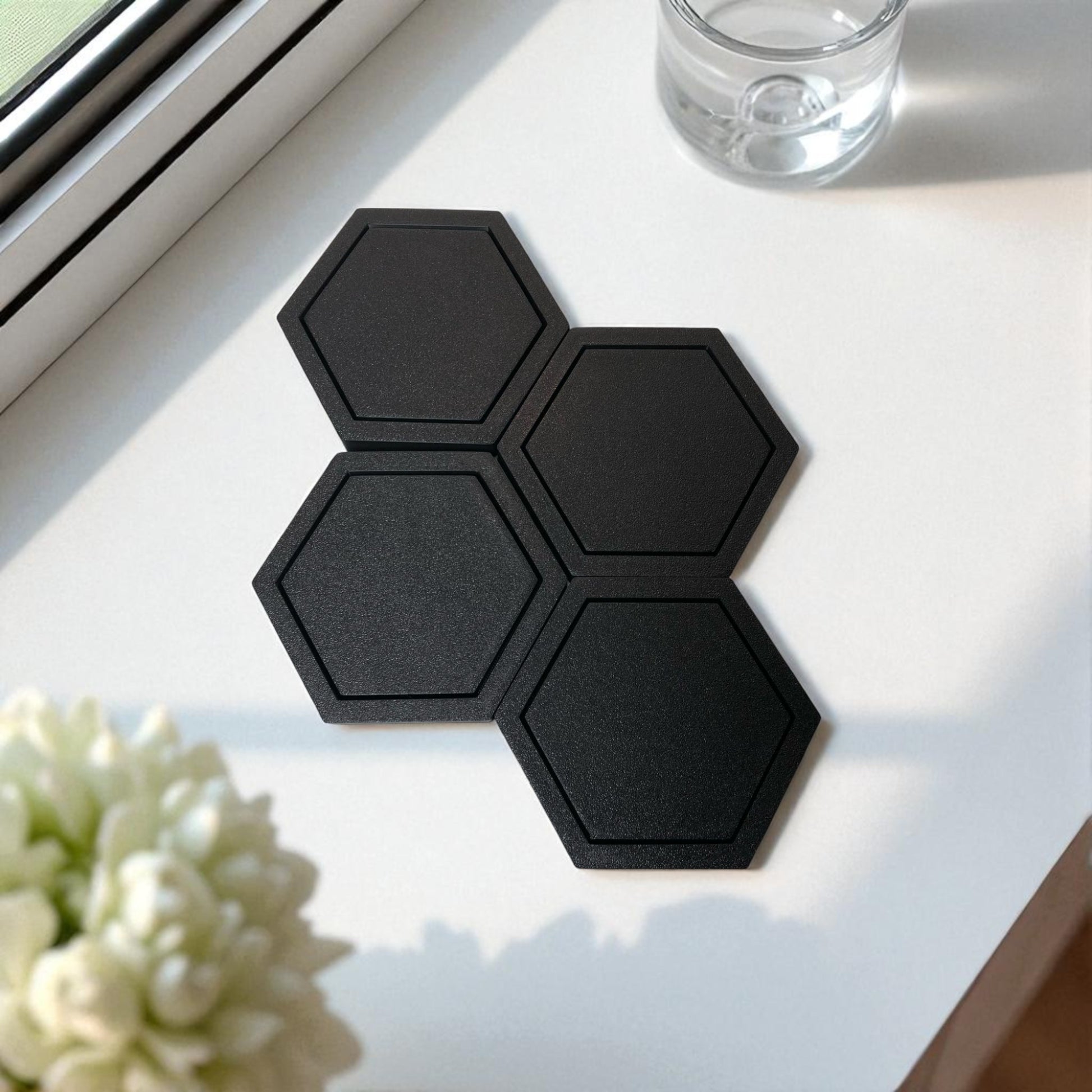 Modern hexagonal coaster in a minimalist design, measuring 115mm x 14mm, perfect for protecting surfaces from hot drinks. Available as a single piece, set of 4, or set of 6. Durable and stylish home decor accessory