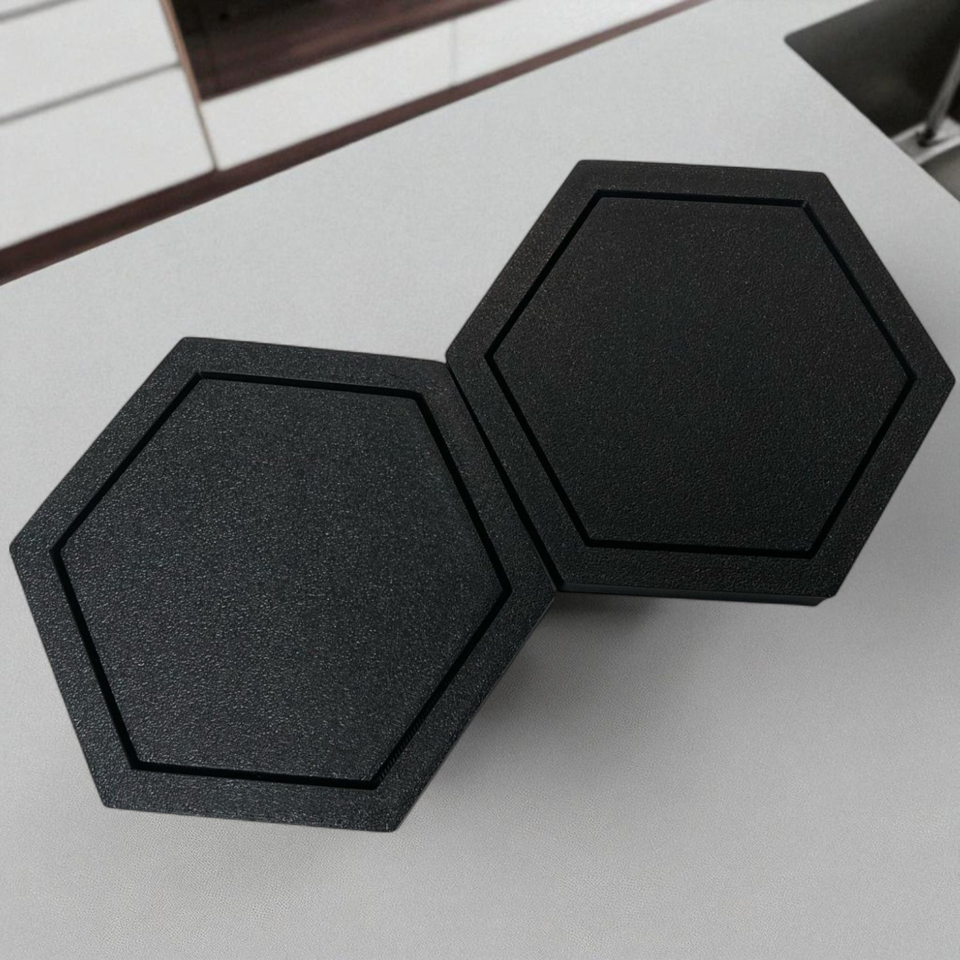 Modern hexagonal coaster in a minimalist design, measuring 115mm x 14mm, perfect for protecting surfaces from hot drinks. Available as a single piece, set of 4, or set of 6. Durable and stylish home decor accessory