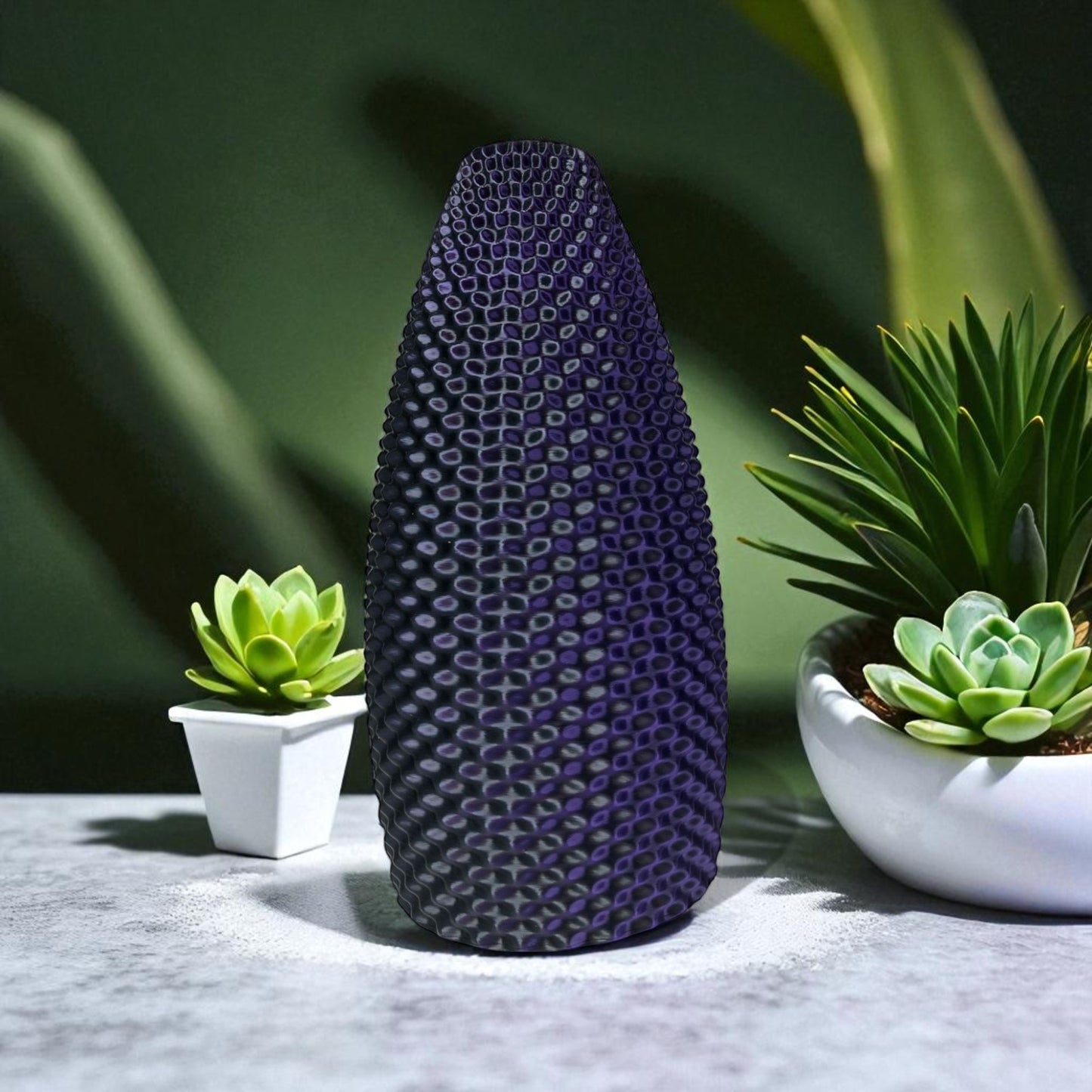 textured purple vase with green plants in the background