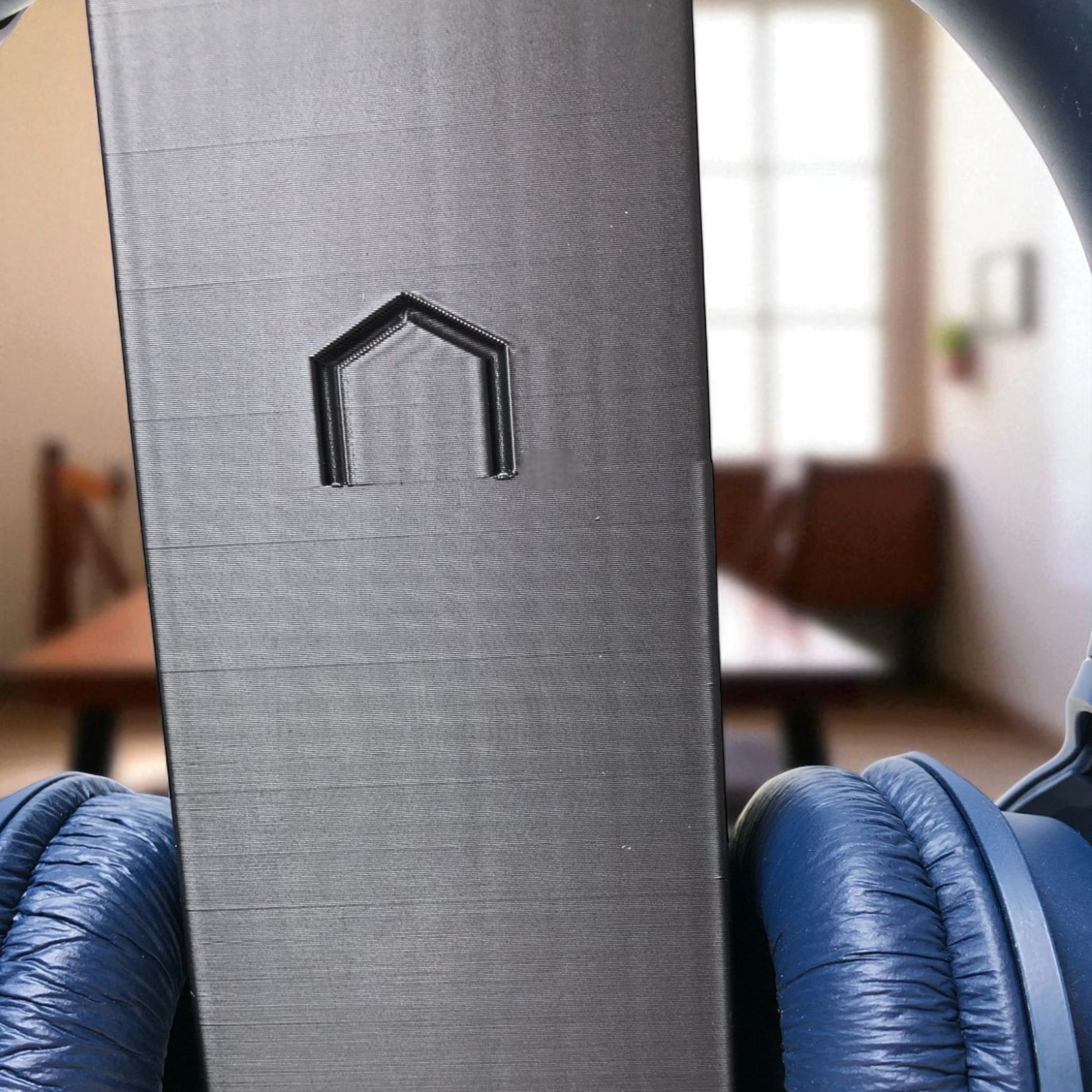 Sleek rectangular headphone stand with a modern minimalist design, featuring a small notch for hanging headphones—ideal for desk organization, gaming setups, or home offices.