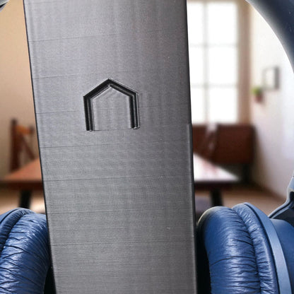 Sleek rectangular headphone stand with a modern minimalist design, featuring a small notch for hanging headphones—ideal for desk organization, gaming setups, or home offices.