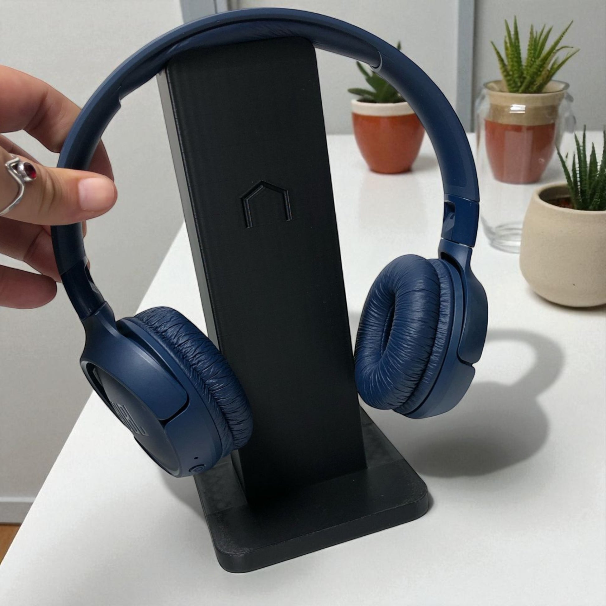 Sleek rectangular headphone stand with a modern minimalist design, featuring a small notch for hanging headphones—ideal for desk organization, gaming setups, or home offices.