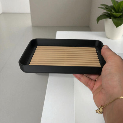 Modern soap tray with raised drainage support, shown holding a soap bar and pump bottle, perfect for bathroom organization and keeping soap dry


