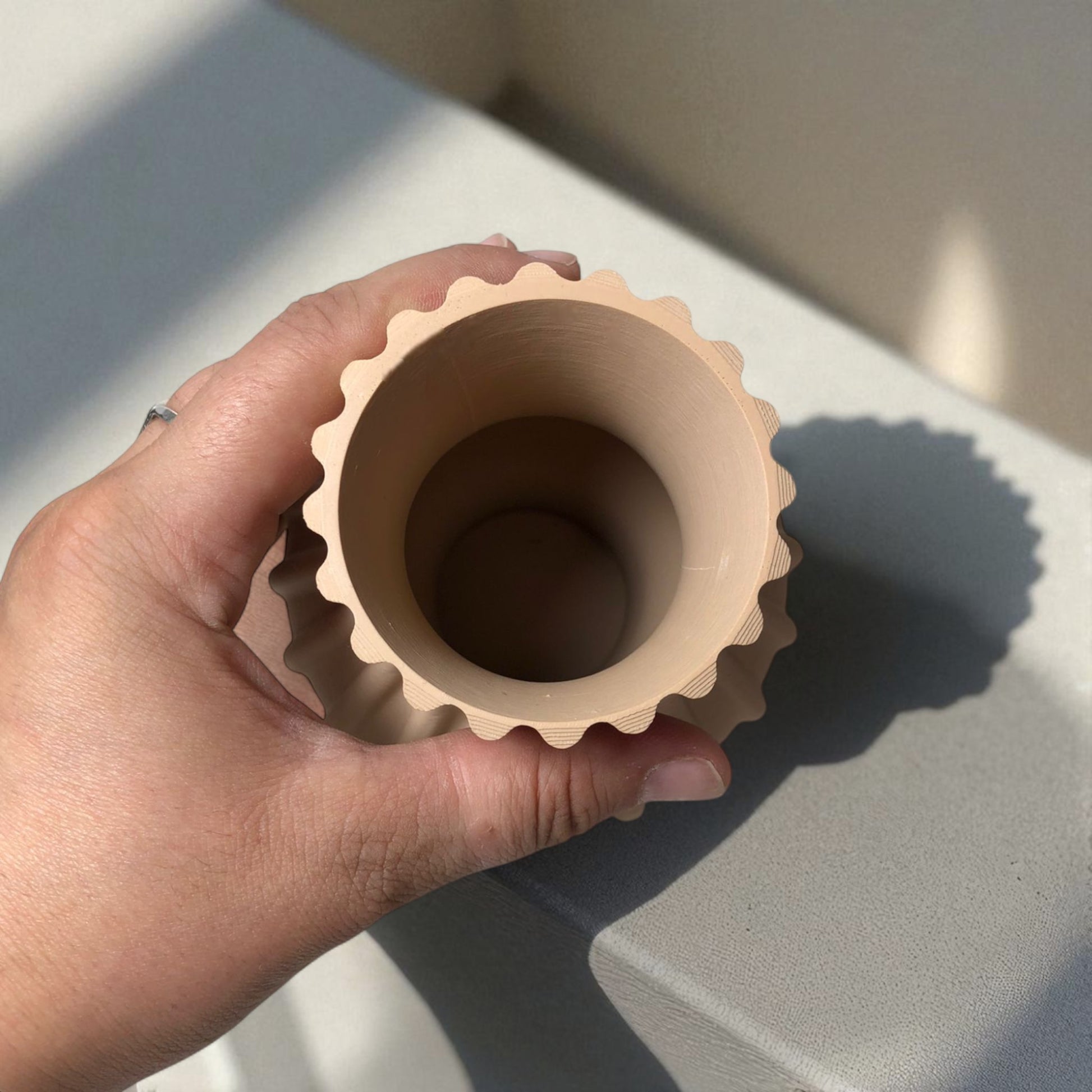 Modern 3D printed sculptural vase with wavy vertical grooves, shown in matte beige color on a white background – minimalist Nordic home decor centerpiece.