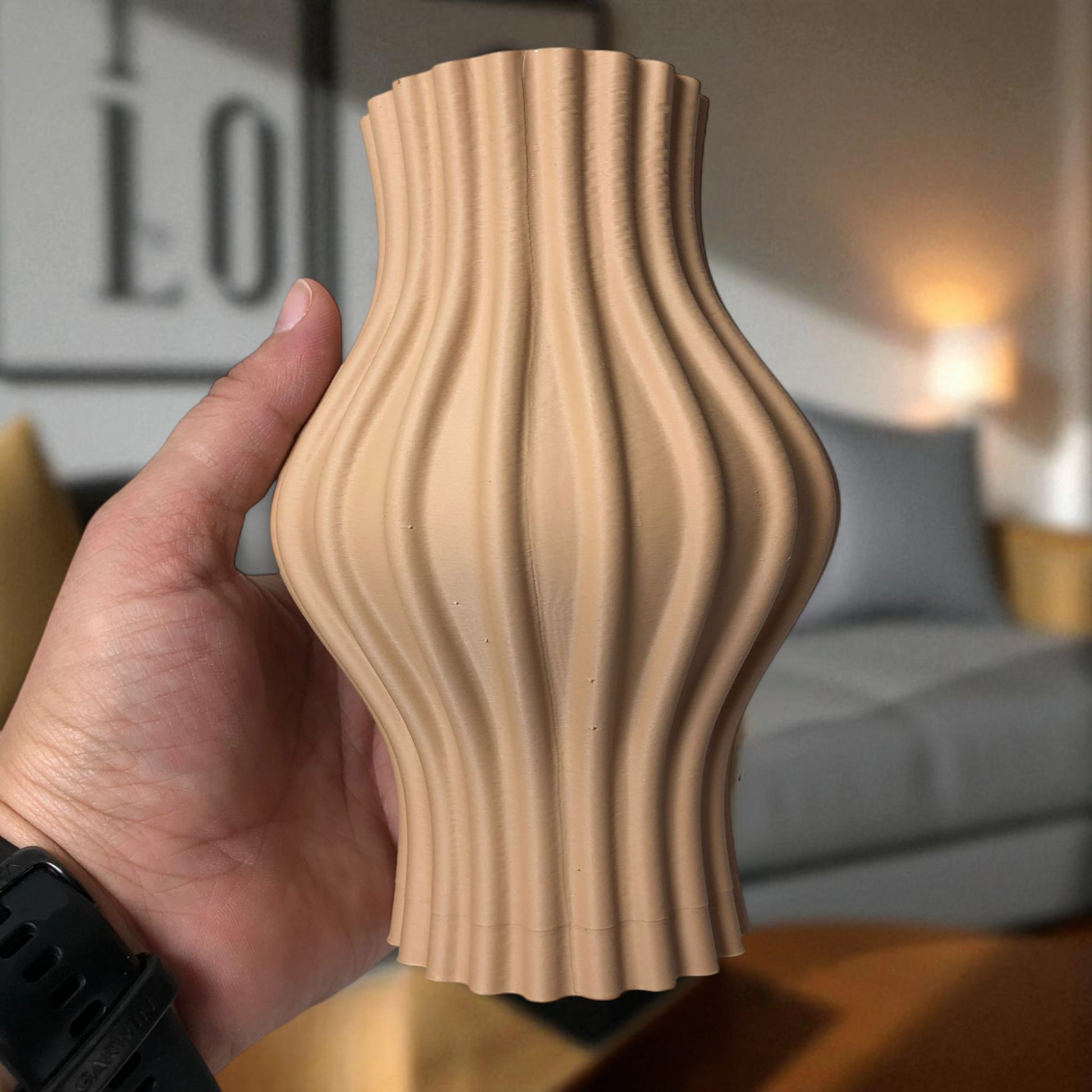 Modern 3D printed sculptural vase with wavy vertical grooves, shown in matte beige color on a white background – minimalist Nordic home decor centerpiece.