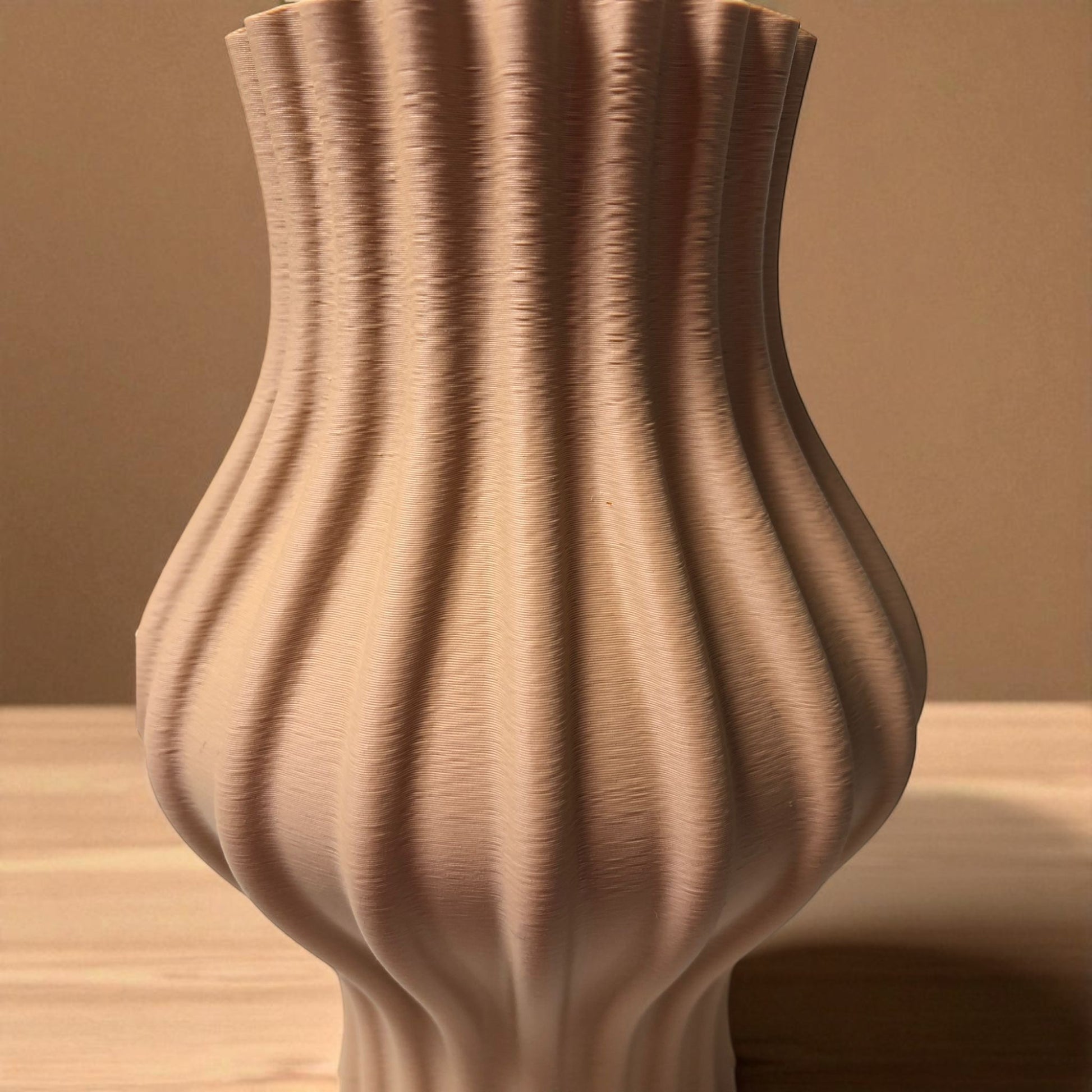 Modern 3D printed sculptural vase with wavy vertical grooves, shown in matte beige color on a white background – minimalist Nordic home decor centerpiece.