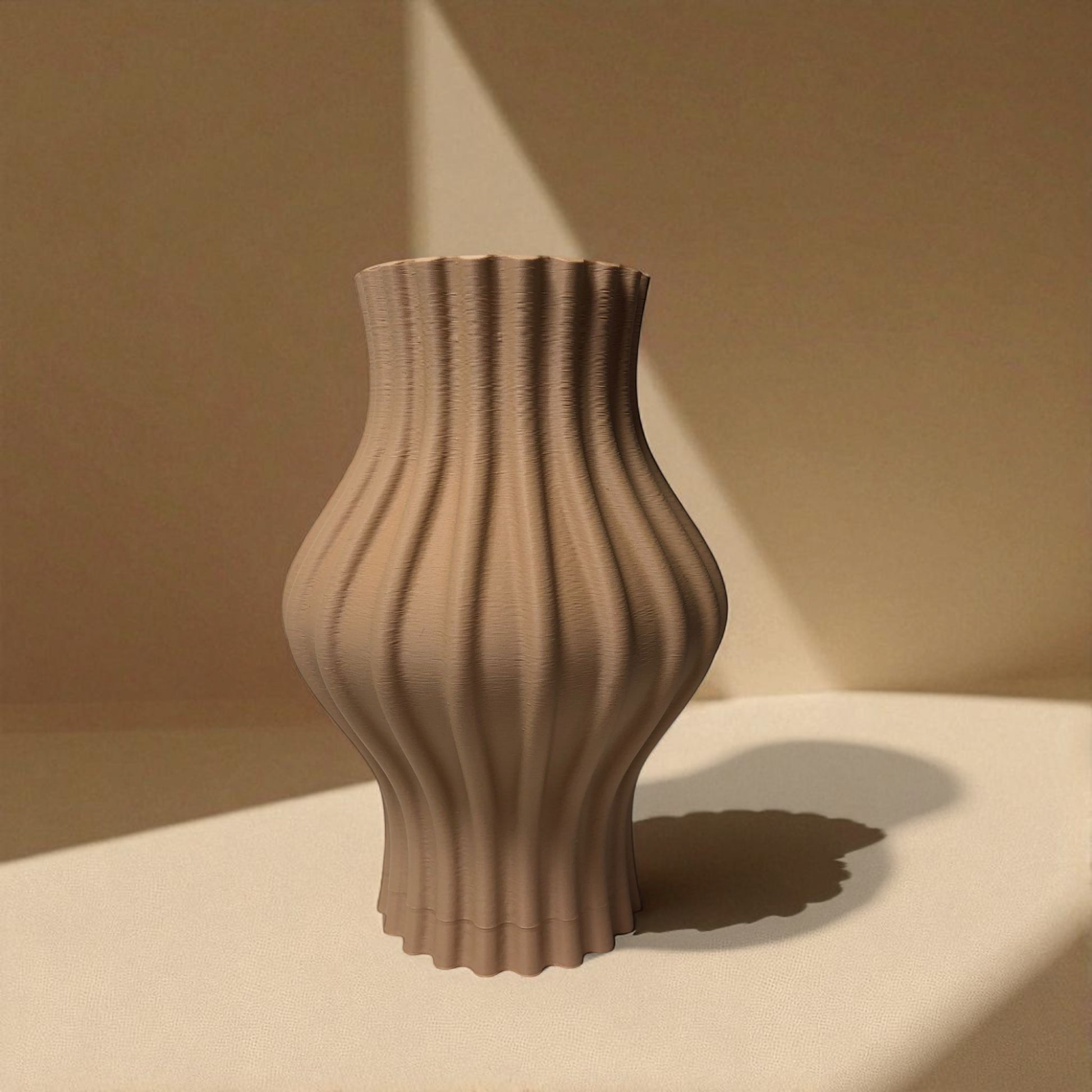 Modern 3D printed sculptural vase with wavy vertical grooves, shown in matte beige color on a white background – minimalist Nordic home decor centerpiece.