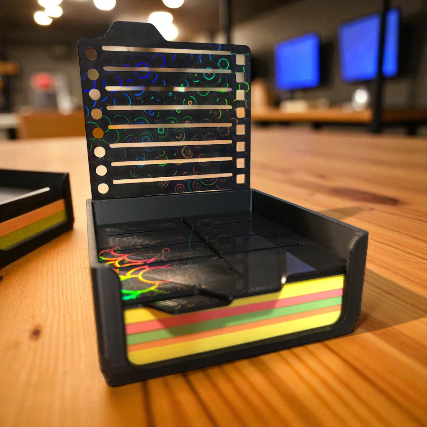 sticky note holder with colorful sticky notes and three reusable stencils, designed for organizing notes and boosting productivity at a work desk