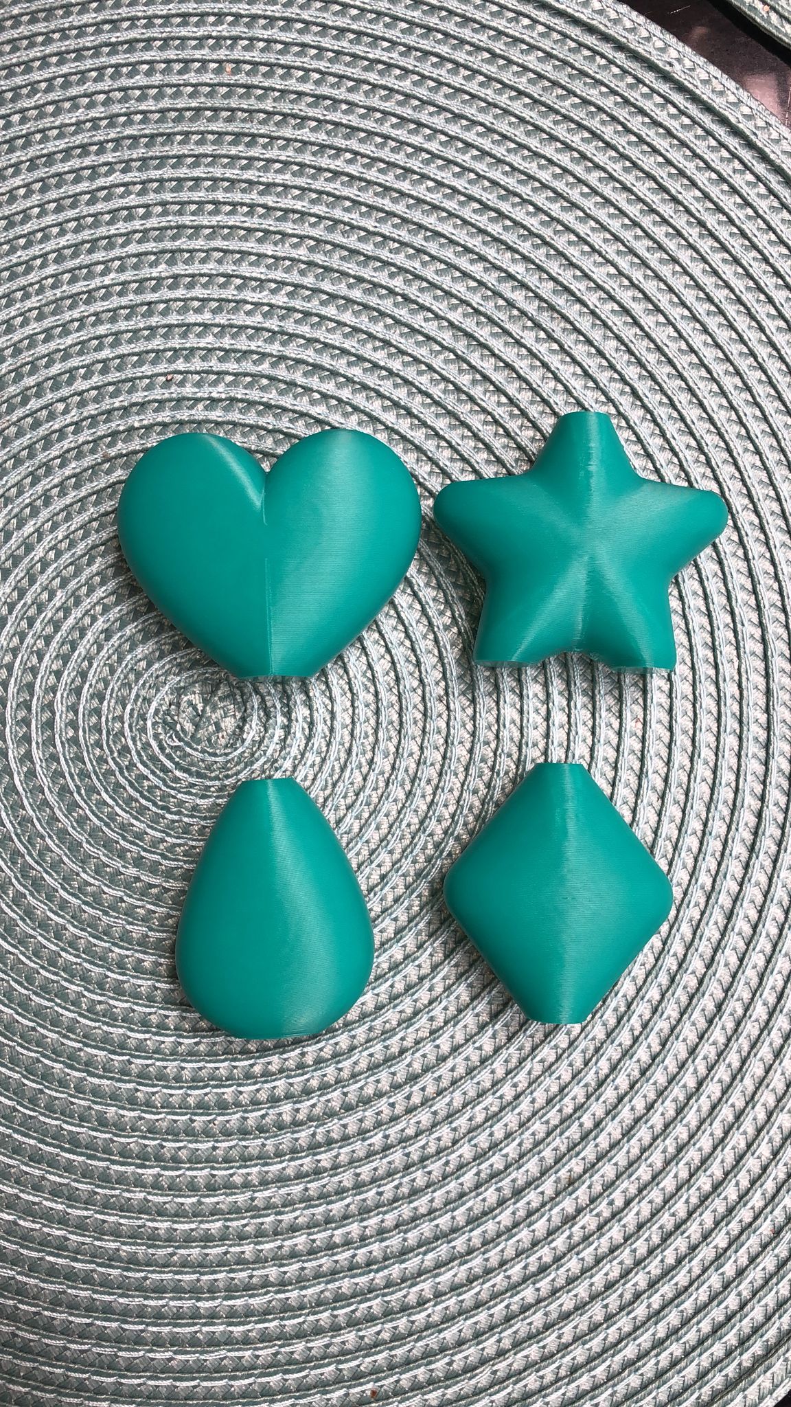 Set of mini magnetic vases in heart, star, diamond, and teardrop shapes, attached to a refrigerator and holding small colorful flowers, displayed in red and white colors.