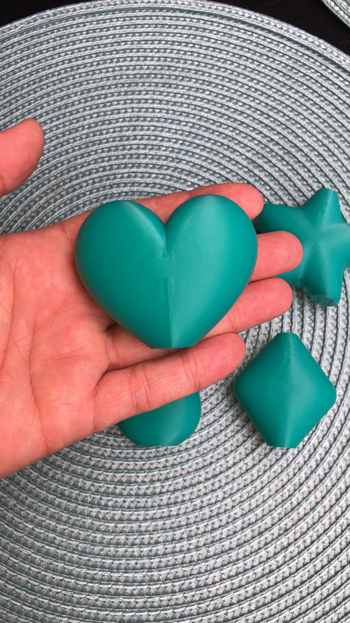 Set of mini magnetic vases in heart, star, diamond, and teardrop shapes, attached to a refrigerator and holding small colorful flowers, displayed in red and white colors.