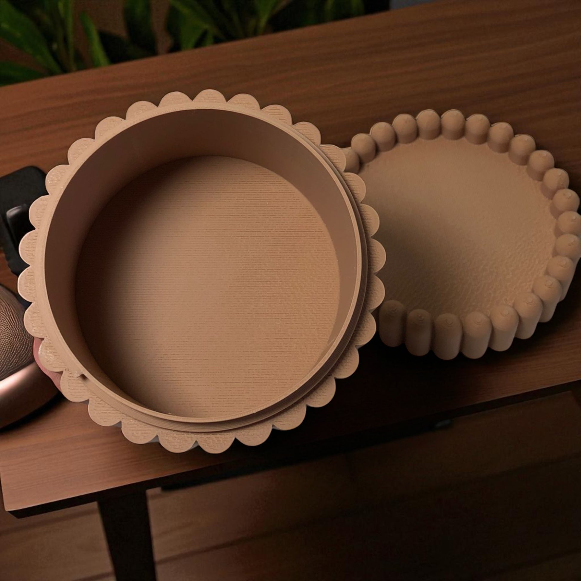3D printed macaron-style jar with a rounded lid and ribbed cookie-like sides, shown in brown and pink colors, used for vanity or bathroom storage.