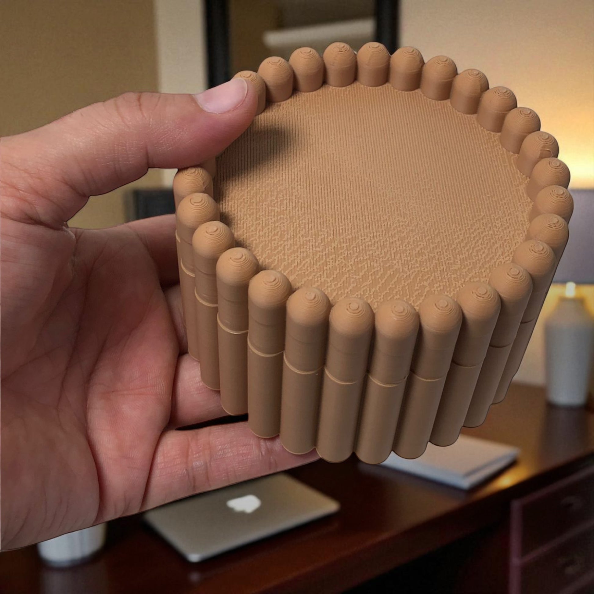 3D printed macaron-style jar with a rounded lid and ribbed cookie-like sides, shown in brown and pink colors, used for vanity or bathroom storage.