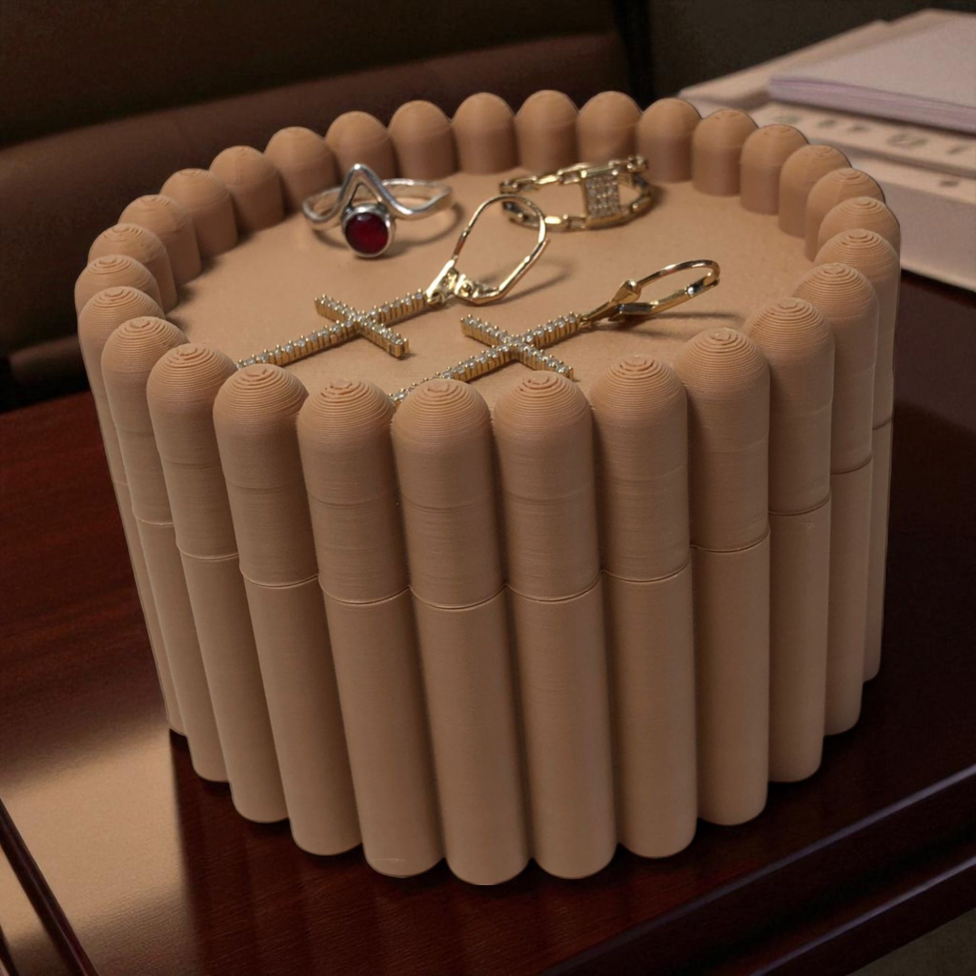3D printed macaron-style jar with a rounded lid and ribbed cookie-like sides, shown in brown and pink colors, used for vanity or bathroom storage.