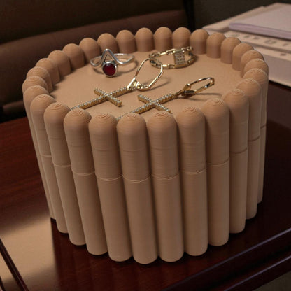 3D printed macaron-style jar with a rounded lid and ribbed cookie-like sides, shown in brown and pink colors, used for vanity or bathroom storage.