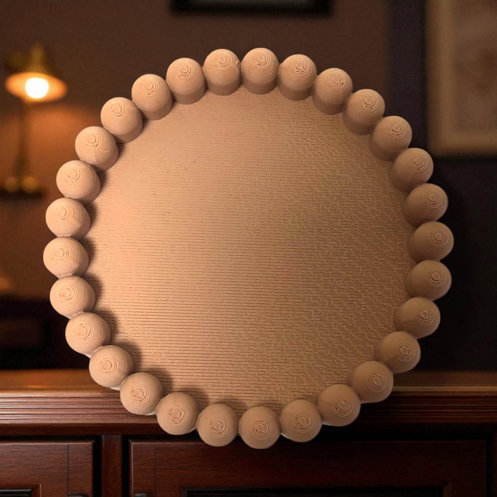 3D printed macaron-style jar with a rounded lid and ribbed cookie-like sides, shown in brown and pink colors, used for vanity or bathroom storage.