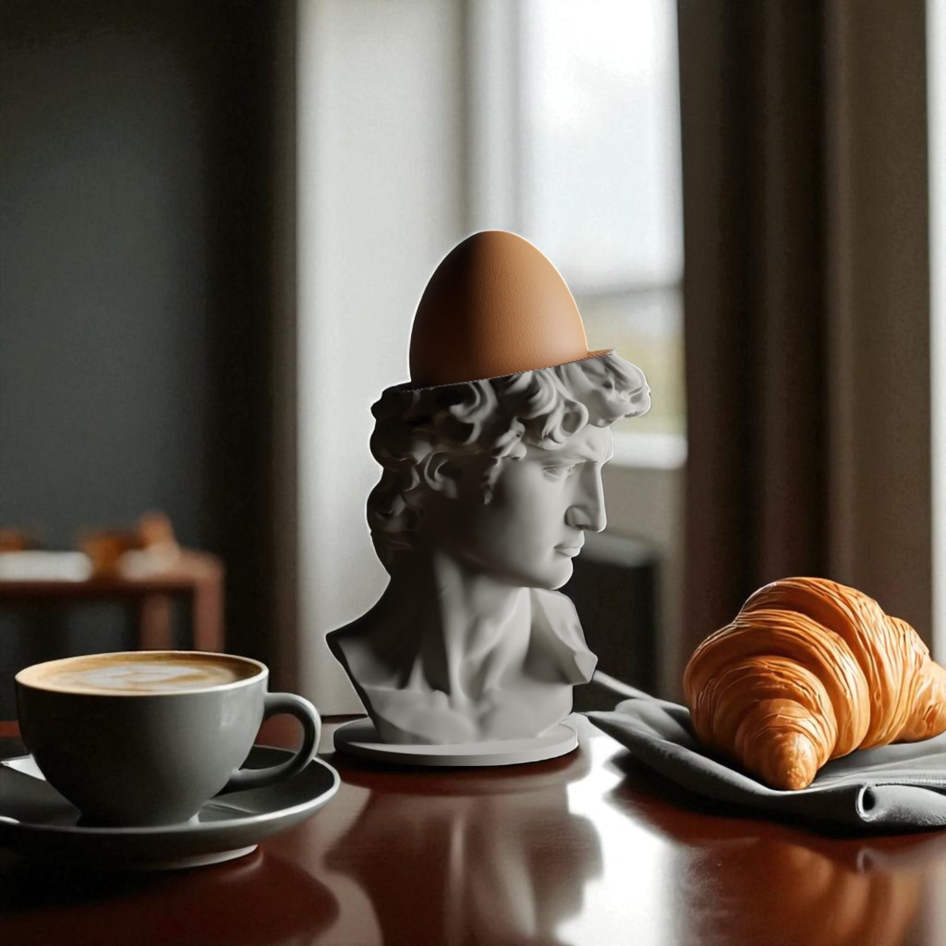 3D printed male bust egg cup in classical sculpture style, featuring a hollowed head holding a boiled egg. Unique breakfast decor piece in white PLA, perfect for Easter table settings or artistic kitchen gifts.