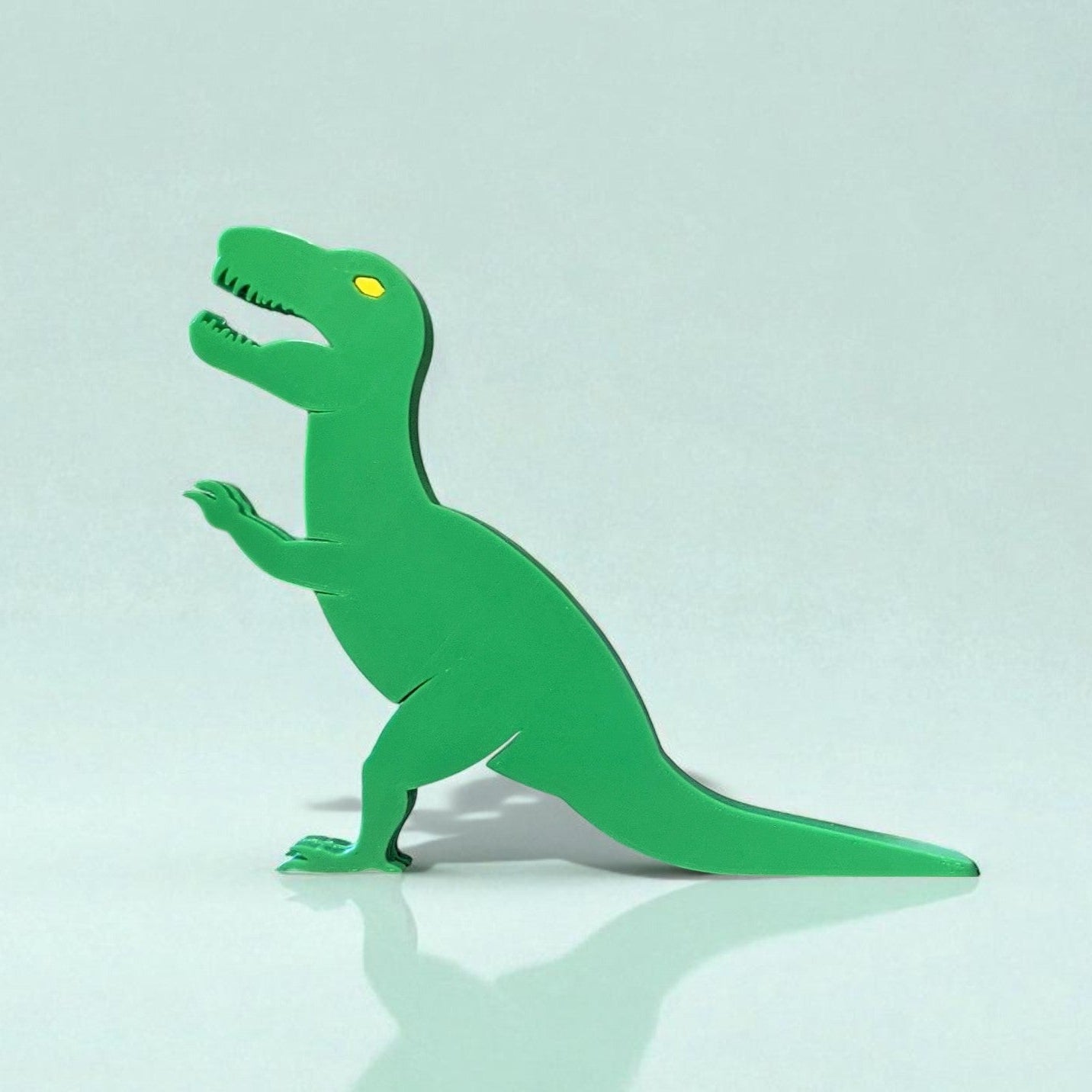 A playful Dino Door Stopper designed in the shape of a dinosaur, adding a fun and functional touch to any room. This unique door stopper keeps doors in place with a charming prehistoric flair