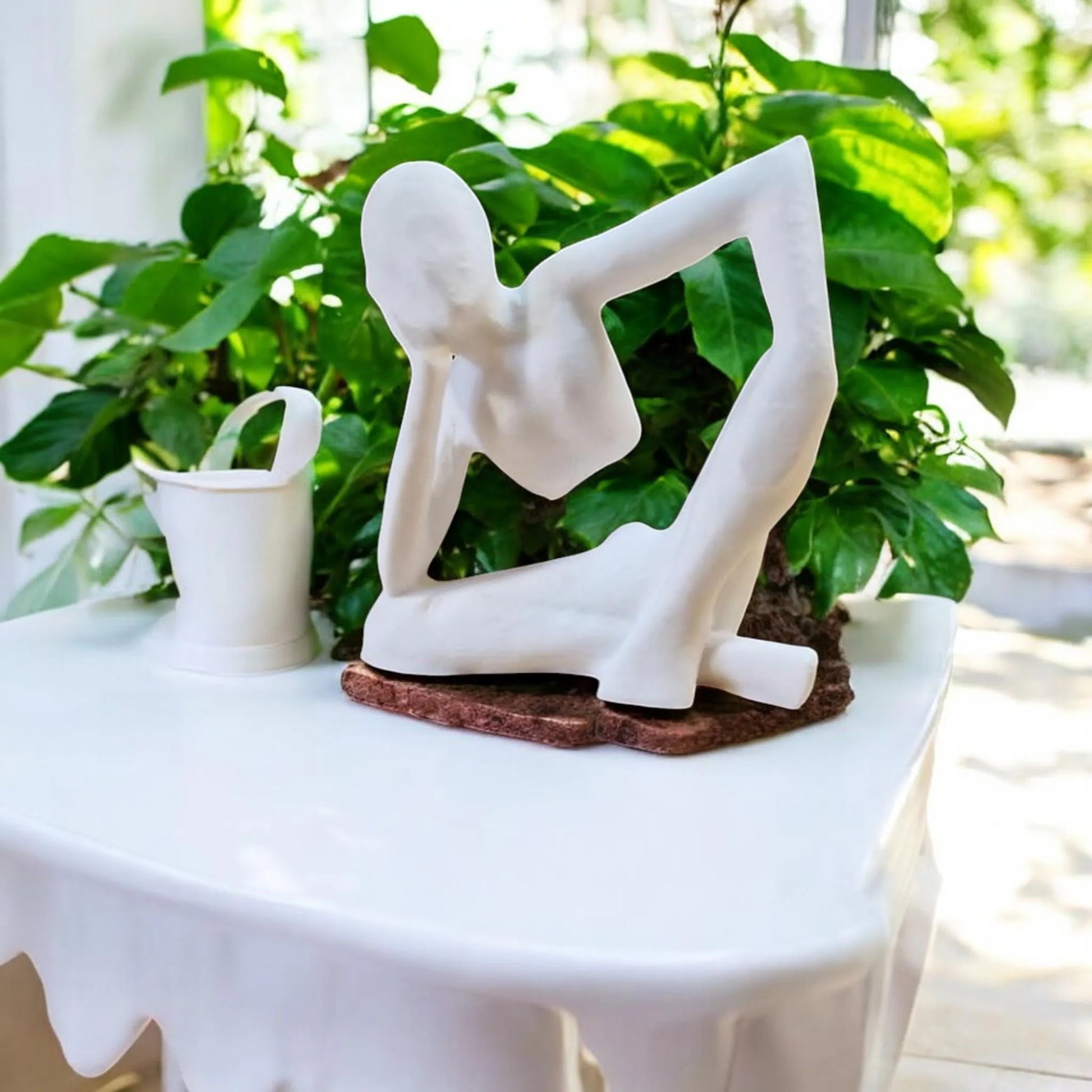 Harmony Meditation Statue A serene statue depicting a man sitting in a yoga position, deep in thought, perfect for creating a calming and meditative atmosphere