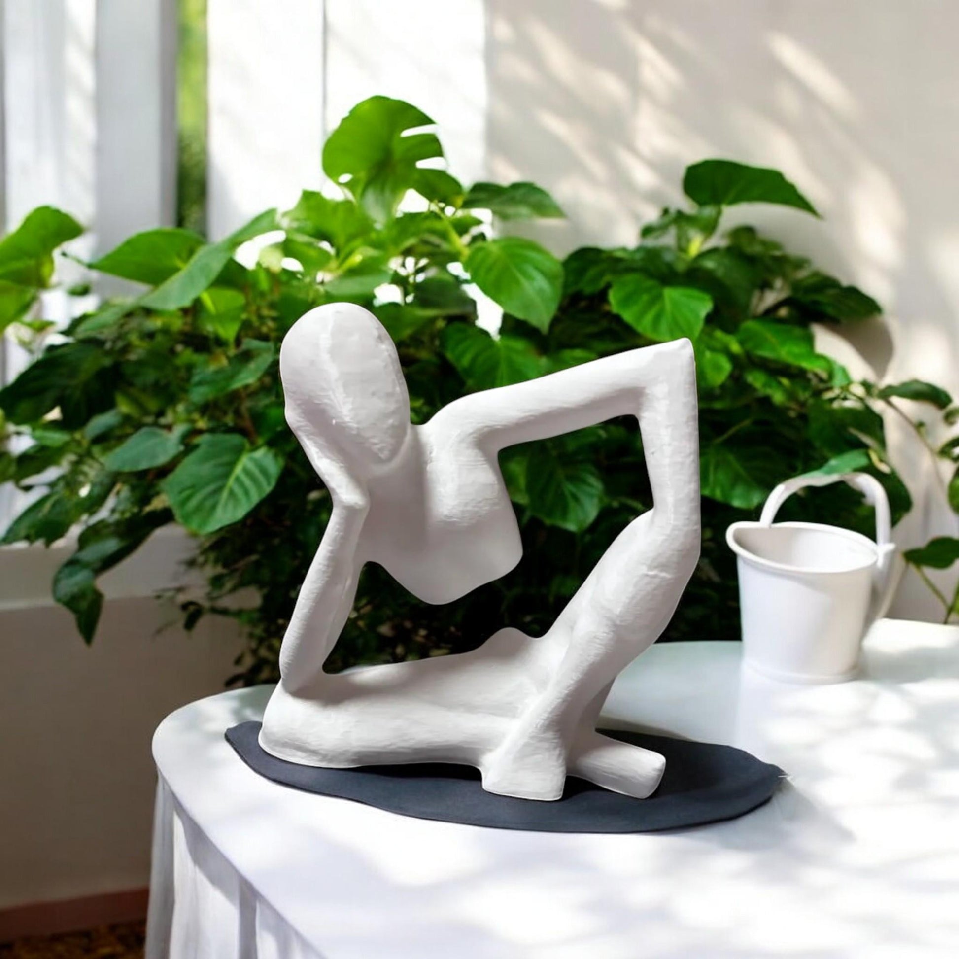 Harmony Meditation Statue A serene statue depicting a man sitting in a yoga position, deep in thought, perfect for creating a calming and meditative atmosphere