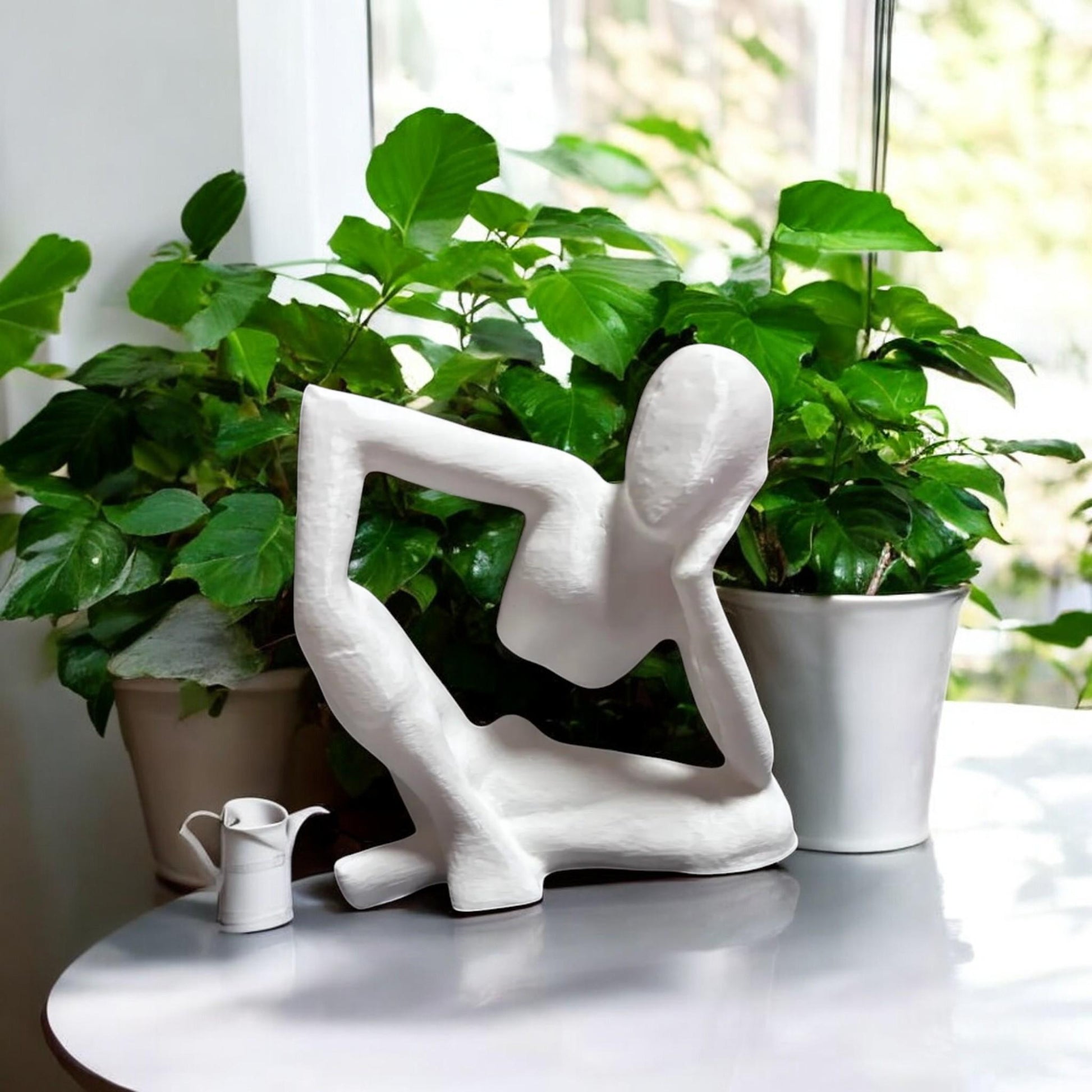 Harmony Meditation Statue A serene statue depicting a man sitting in a yoga position, deep in thought, perfect for creating a calming and meditative atmosphere