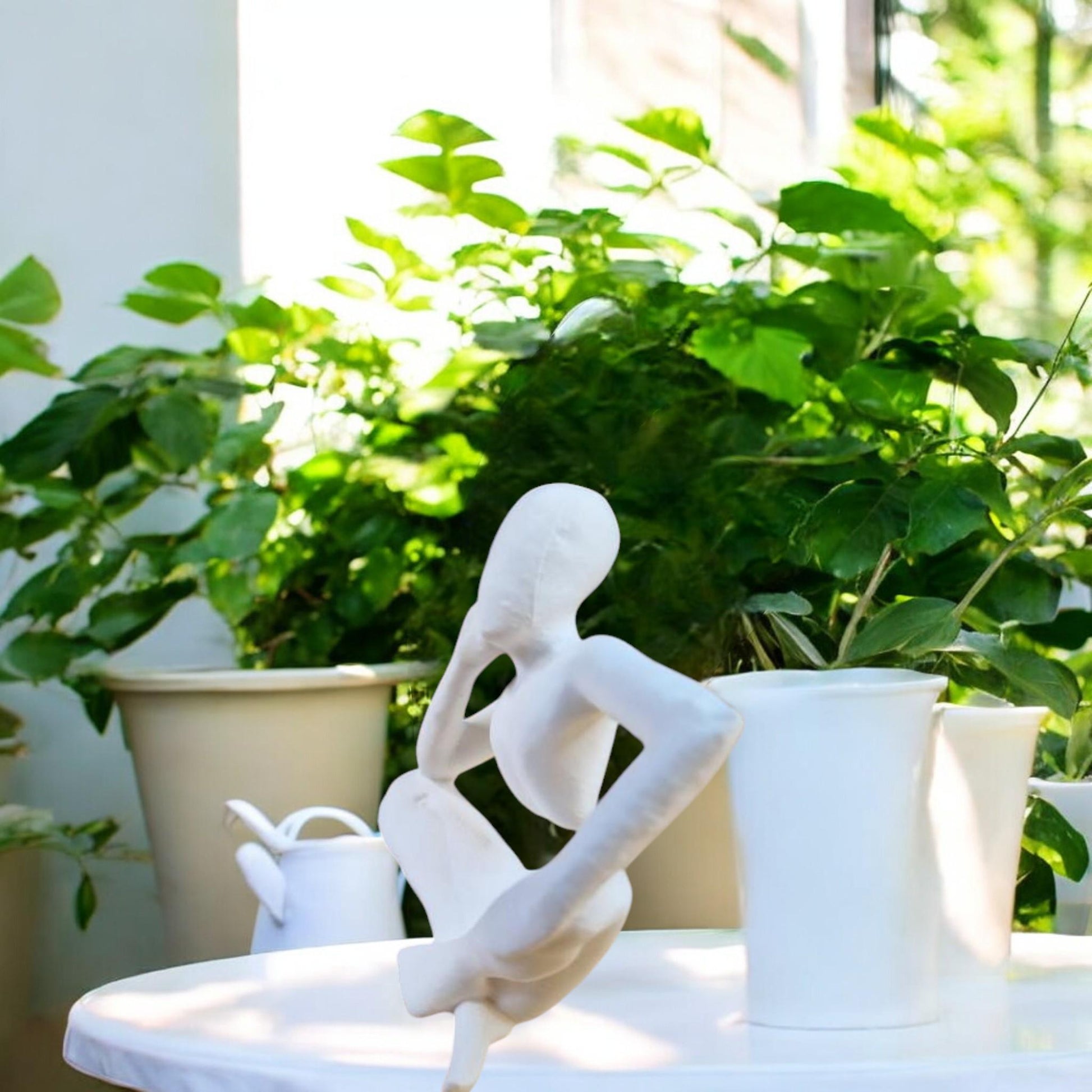 Harmony Meditation Statue A serene statue depicting a man sitting in a yoga position, deep in thought, perfect for creating a calming and meditative atmosphere