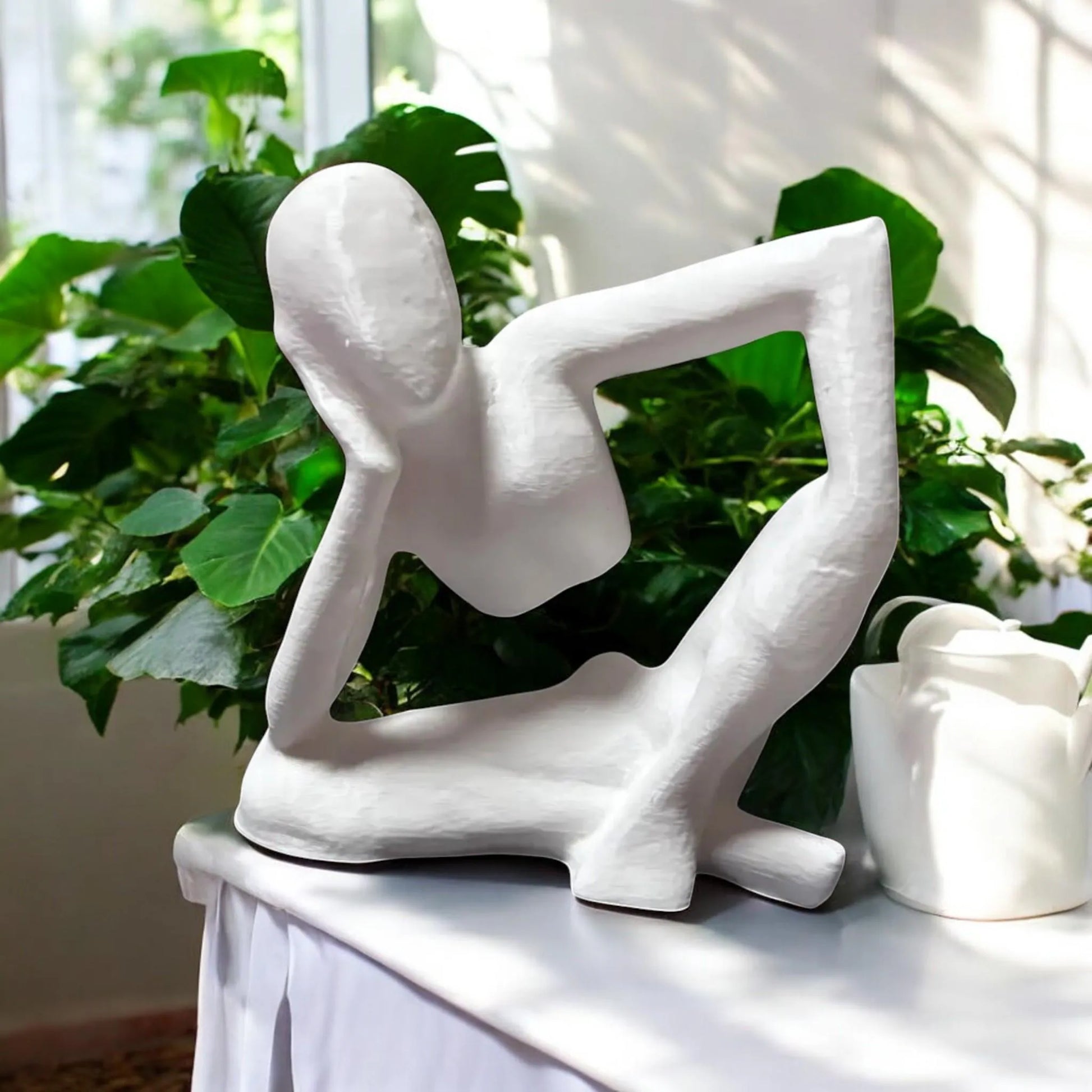 Harmony Meditation Statue A serene statue depicting a man sitting in a yoga position, deep in thought, perfect for creating a calming and meditative atmosphere
