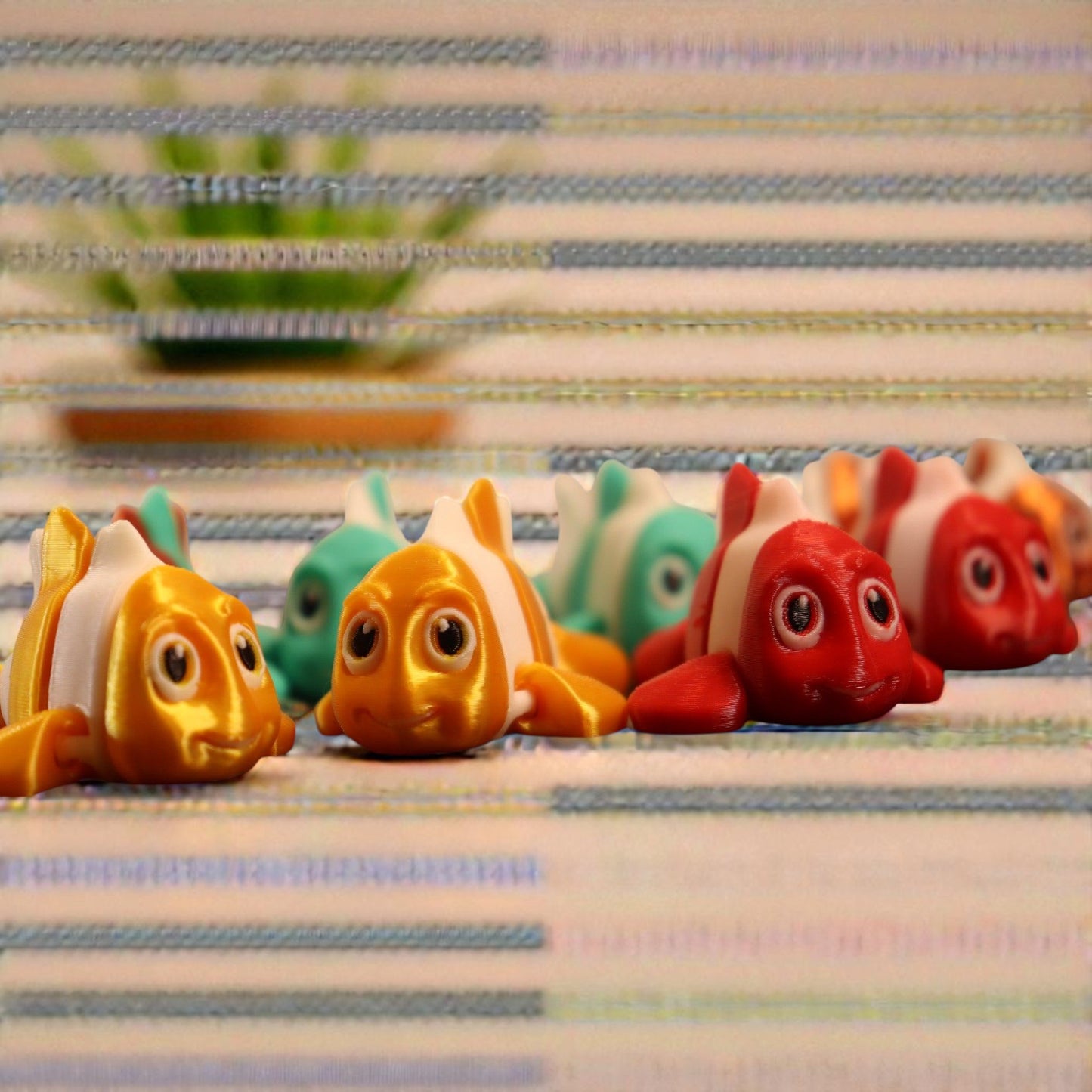 3d printed articulated clown fish toy in vibrant two-tone colors, featuring a cute face and flexible, lifelike movement, perfect as a keychain or playful ocean-themed gift.