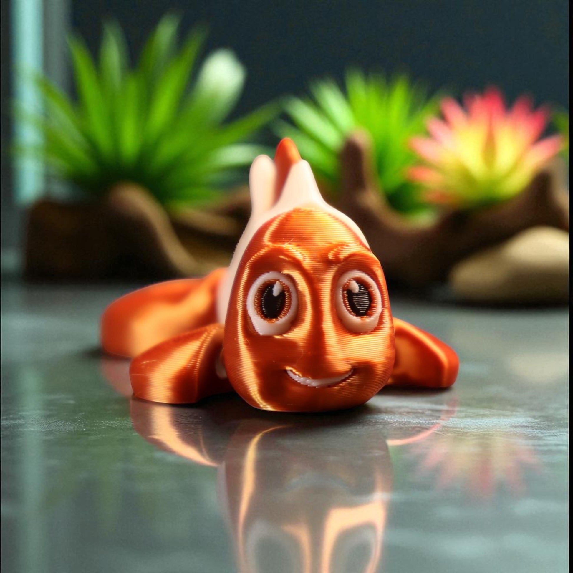 3D printed articulated clown fish toy in vibrant two-tone colors, featuring a cute face and flexible, lifelike movement, perfect as a keychain or playful ocean-themed gift.