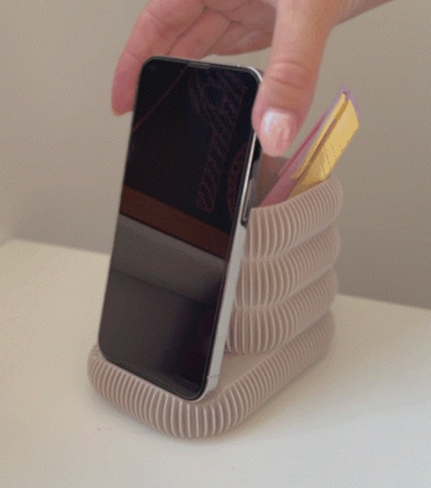 Multifunctional phone stand with an integrated cup holder for brushes, pens, or markers. Made from durable 3D-printed material, this sleek and compact design keeps your essentials organized while holding your phone at the perfect viewing angle. Ideal for desks, makeup stations, or creative workspaces.