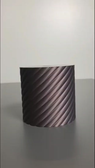 A modern spiral coin bank with a unique closing mechanism. Features a sleek, minimalist design where coins drop smoothly into the bank, and the lid twists shut in a mesmerizing spiral motion. Perfect for stylish and satisfying money-saving!