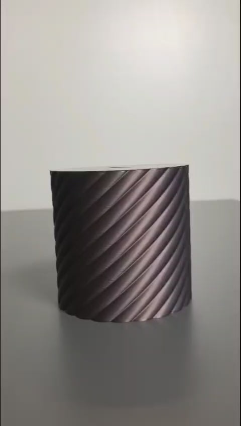 A modern spiral coin bank with a unique closing mechanism. Features a sleek, minimalist design where coins drop smoothly into the bank, and the lid twists shut in a mesmerizing spiral motion. Perfect for stylish and satisfying money-saving!