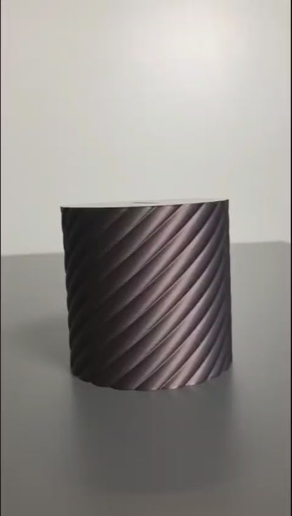 A modern spiral coin bank with a unique closing mechanism. Features a sleek, minimalist design where coins drop smoothly into the bank, and the lid twists shut in a mesmerizing spiral motion. Perfect for stylish and satisfying money-saving!