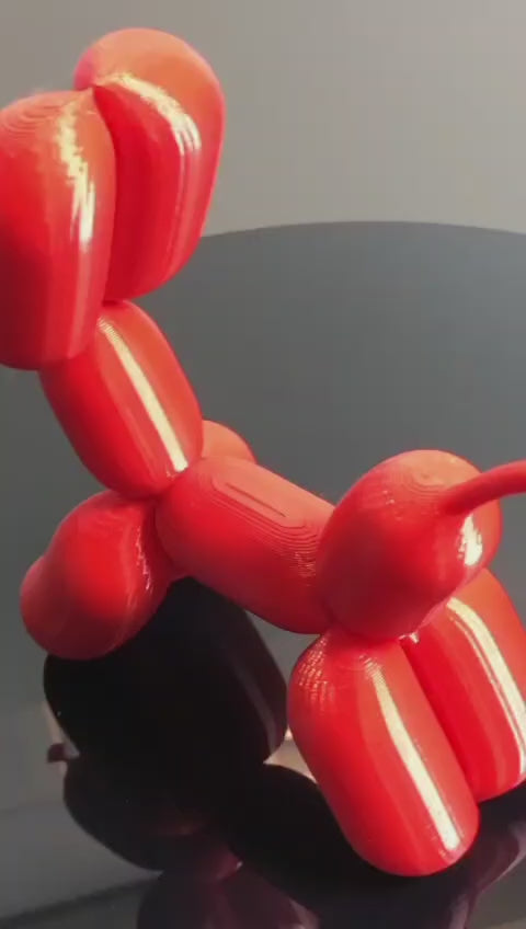 3D-printed figurine resembling a playful dog made from balloons, available in three different sizes. Perfect for home decor, kids' rooms, or as a unique gift for dog lovers.